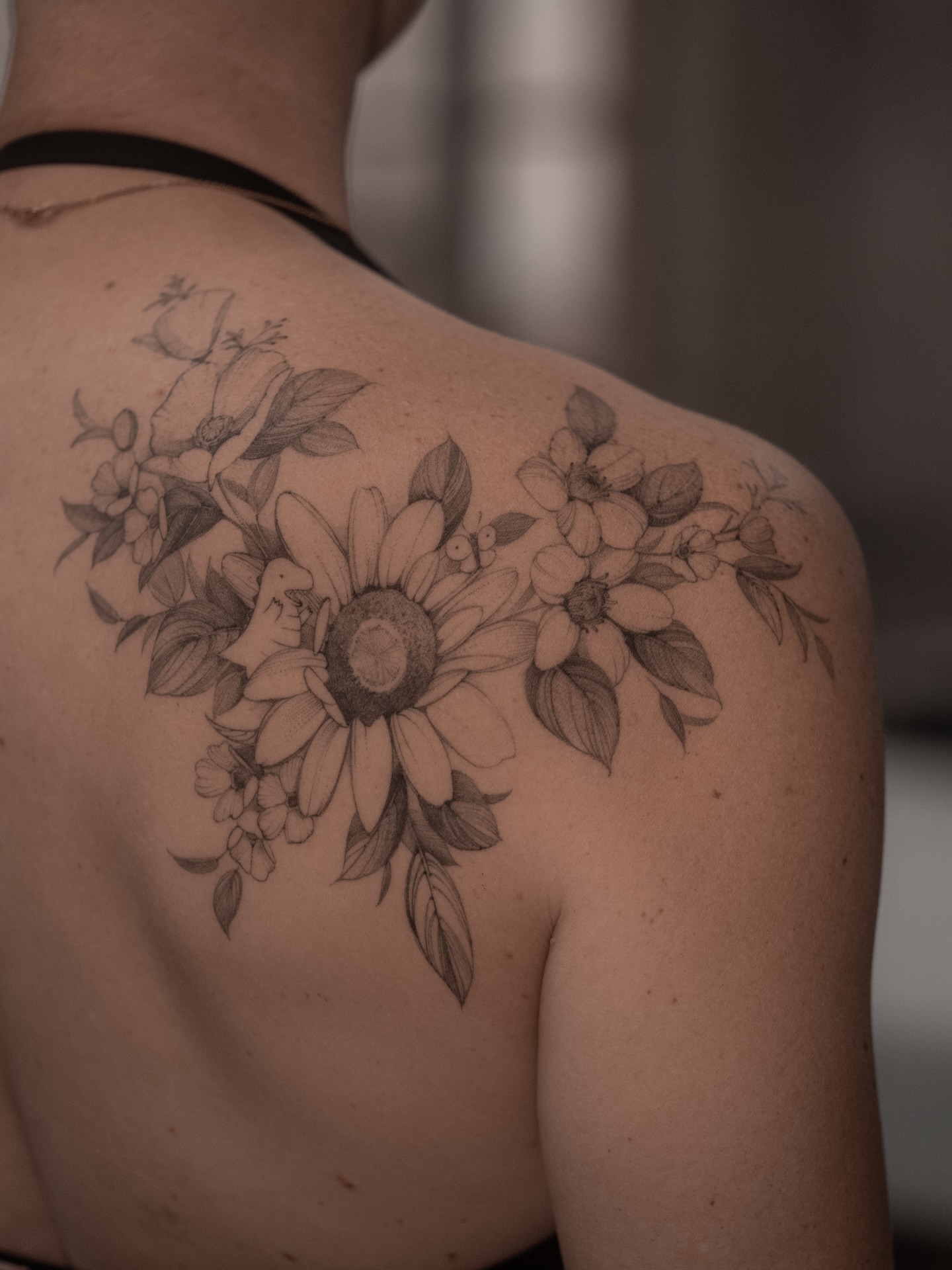 Sunflower bouquet black and grey tattoo on the shoulder by Mary Shekh