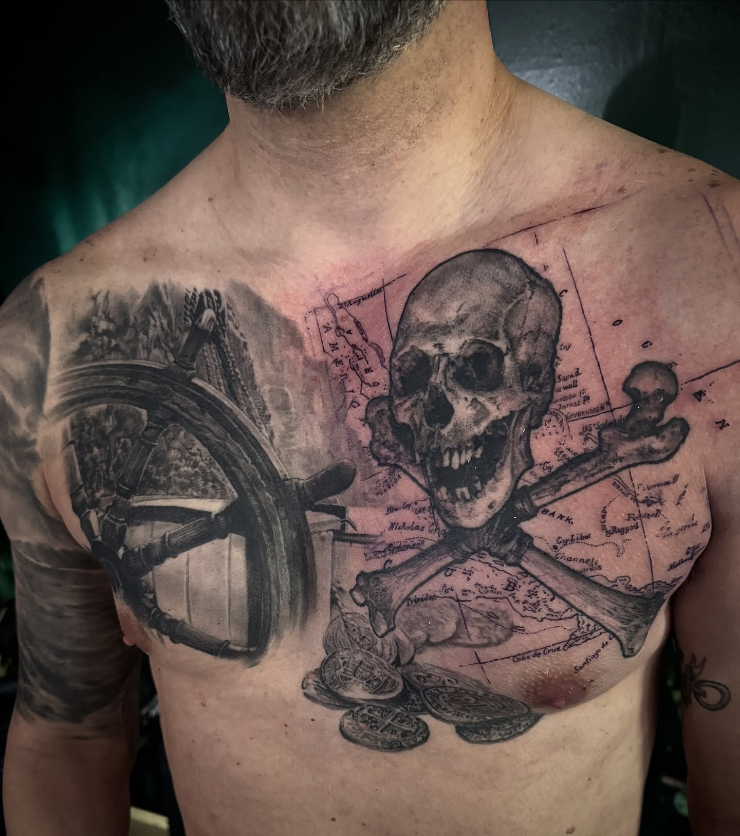 Pirate treasure realism tattoo on the chest by Jake Kirk