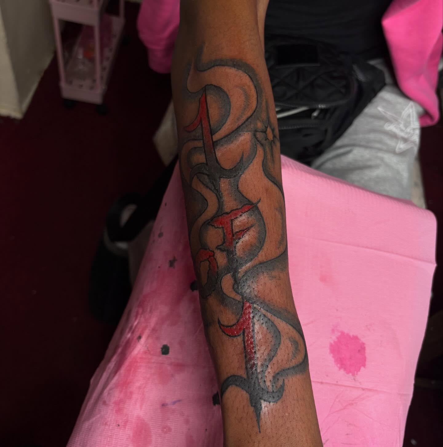 Flame and lettering black and grey tattoo on the forearm by Barbinks Studio🎀