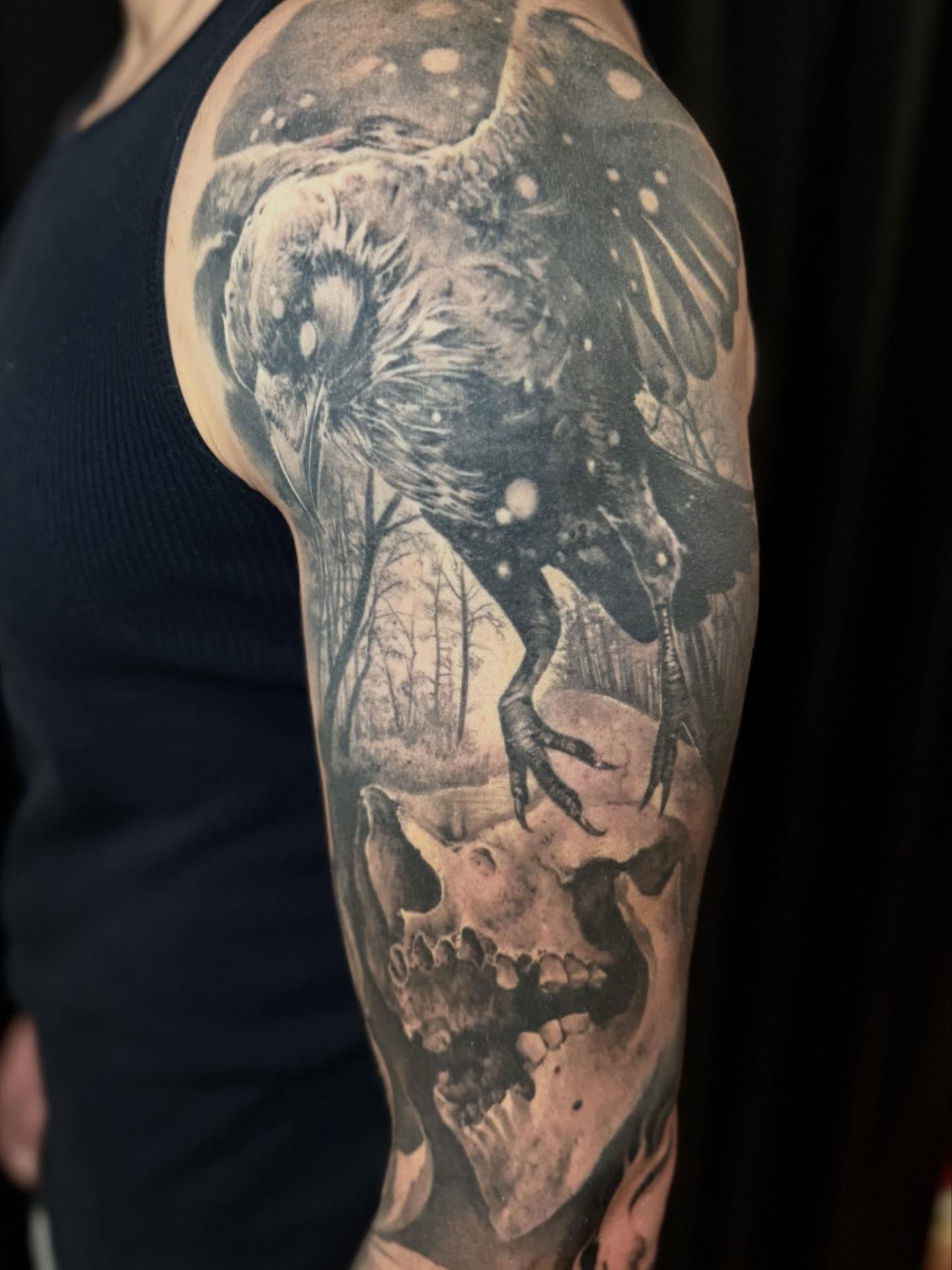 Deer and skull realism tattoo on the upper arm by Gabe Jensen