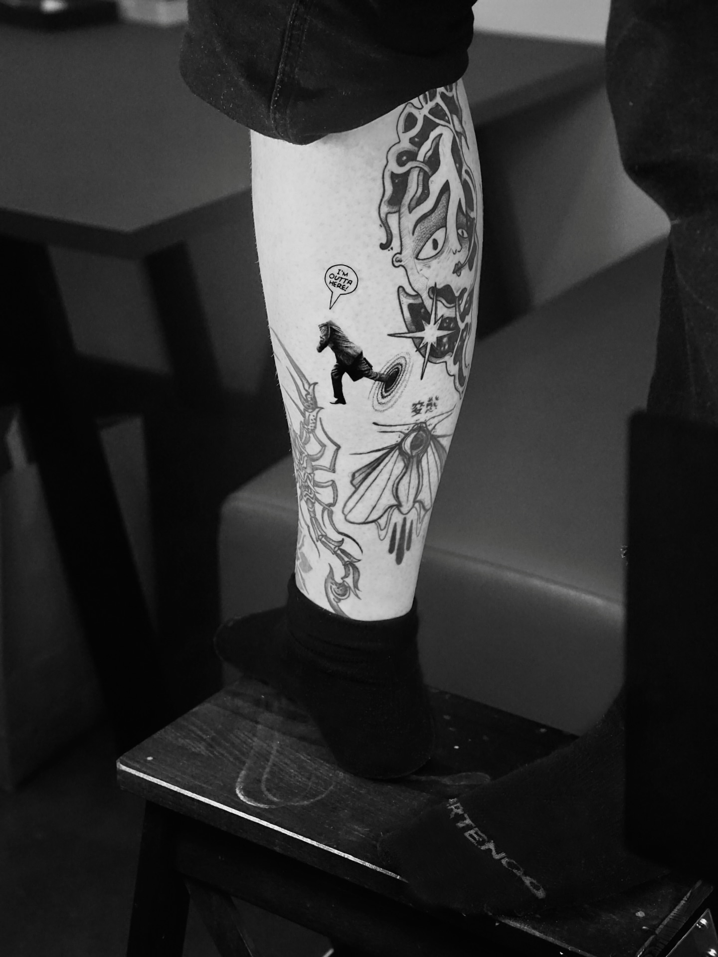 Monster and man black and grey tattoo on the calf by Metin Karaatli