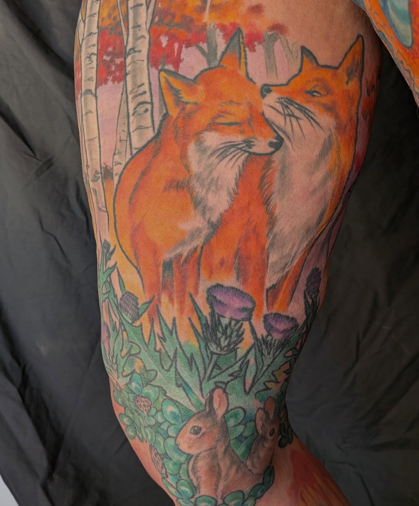Foxes and rabbits realism tattoo on the thigh by Nic Skrade, Minneapolis, Minnesota