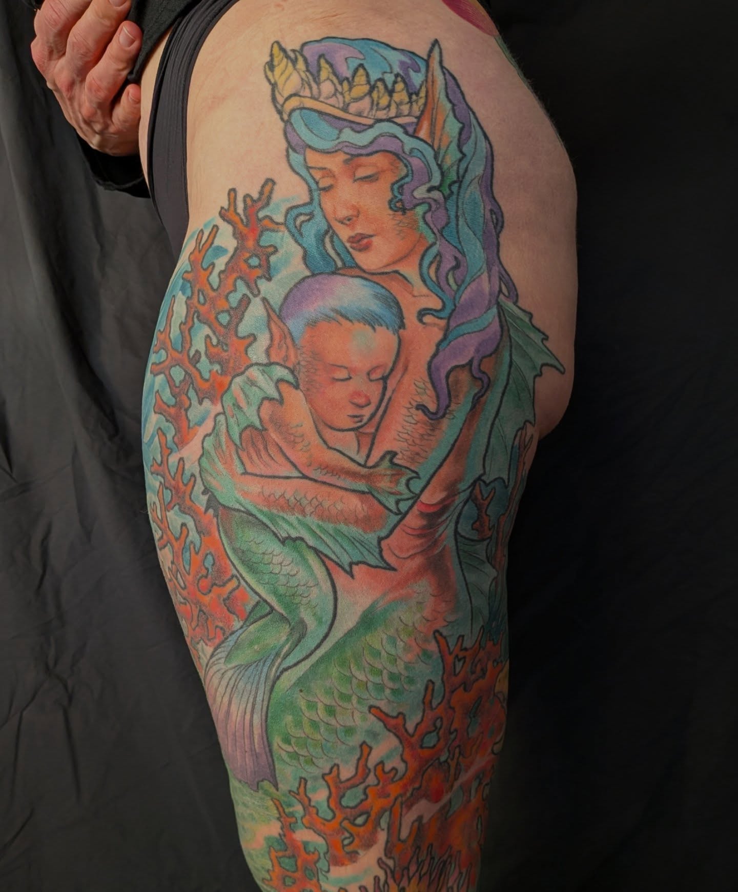 Mermaid holding baby realism tattoo on the upper arm by Nic Skrade, Minneapolis, Minnesota