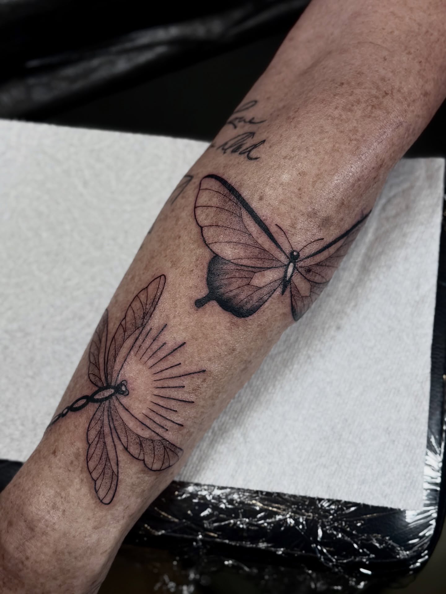 Butterfly and flower black and grey tattoo on the forearm by ♡ Erika Soya ♡