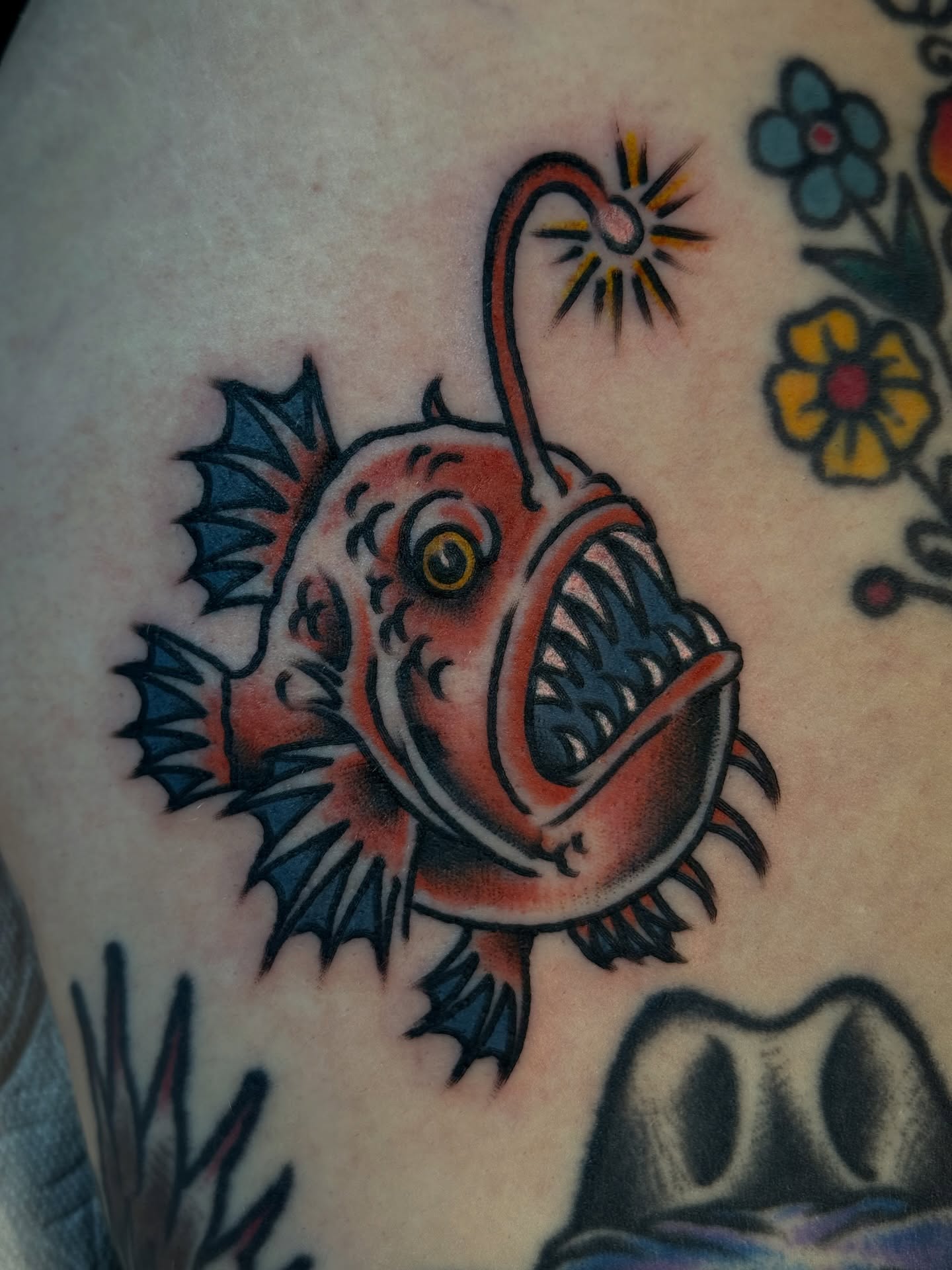 Angler fish American traditional tattoo on the upper arm by Clayton - TRADITIONAL TATTOOS
