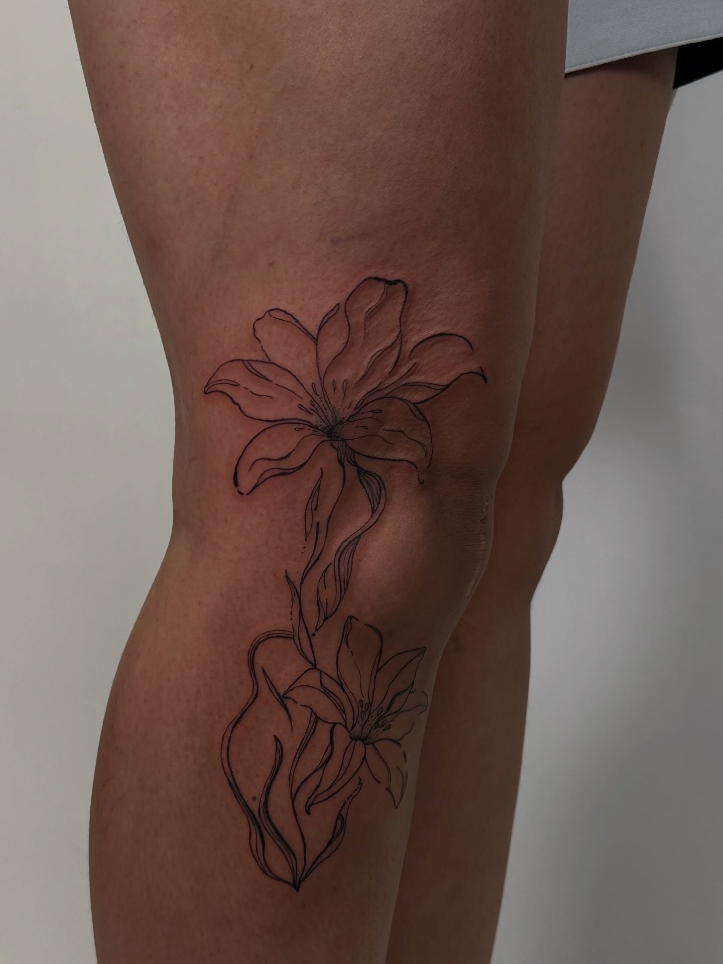Lily fine line tattoo on the thigh by πππππππ π‘ π±πππππ πΌπ°