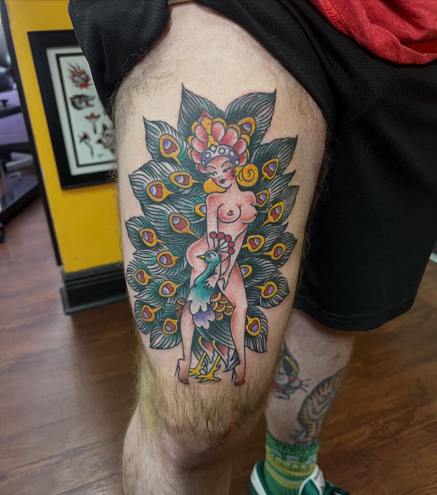 Peacock fairy American traditional tattoo on the thigh by Keith Underwood