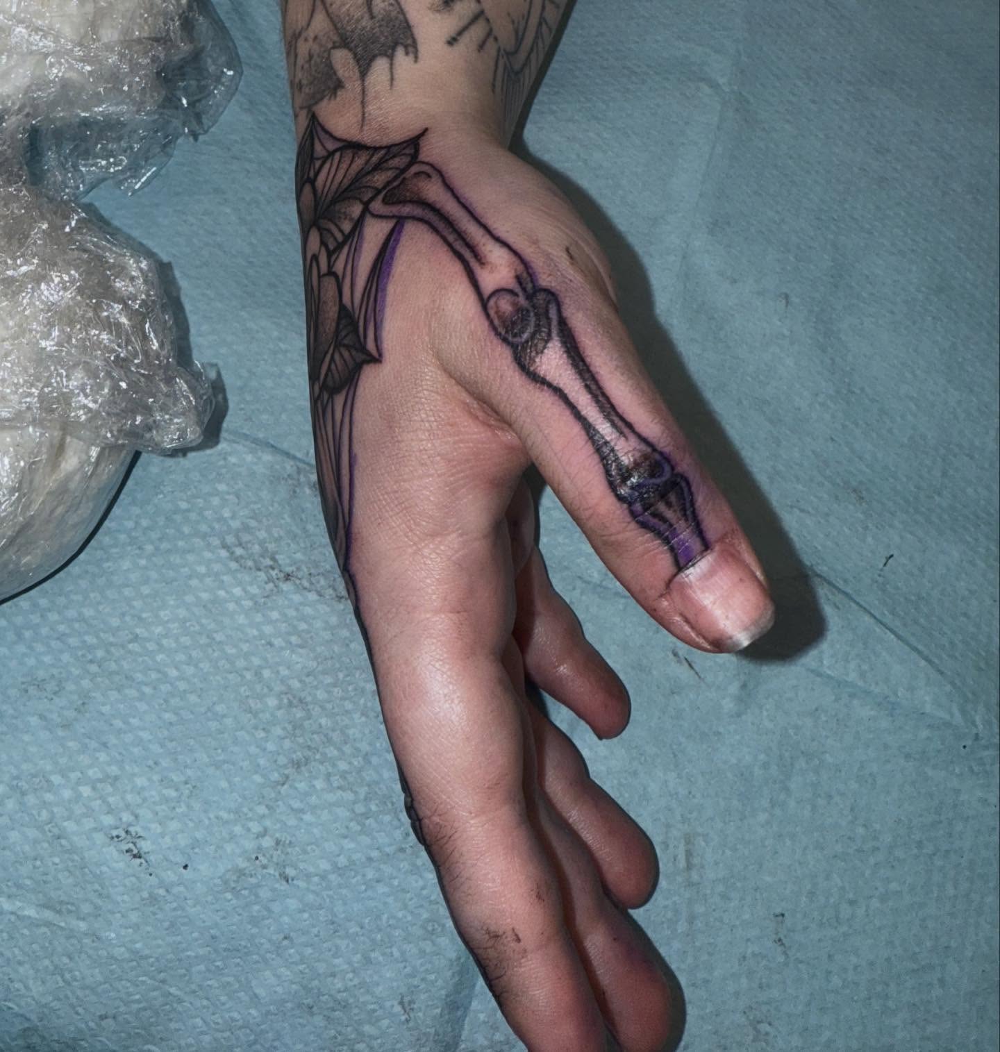 Skeleton hand black and grey tattoo on the hand by Laurito
