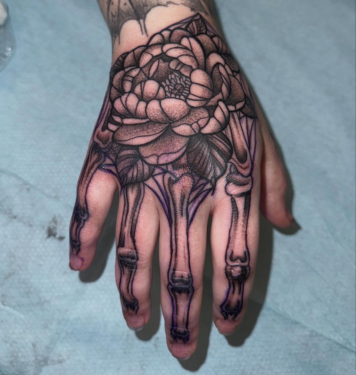 Flower skeleton realism tattoo on the hand by Laurito
