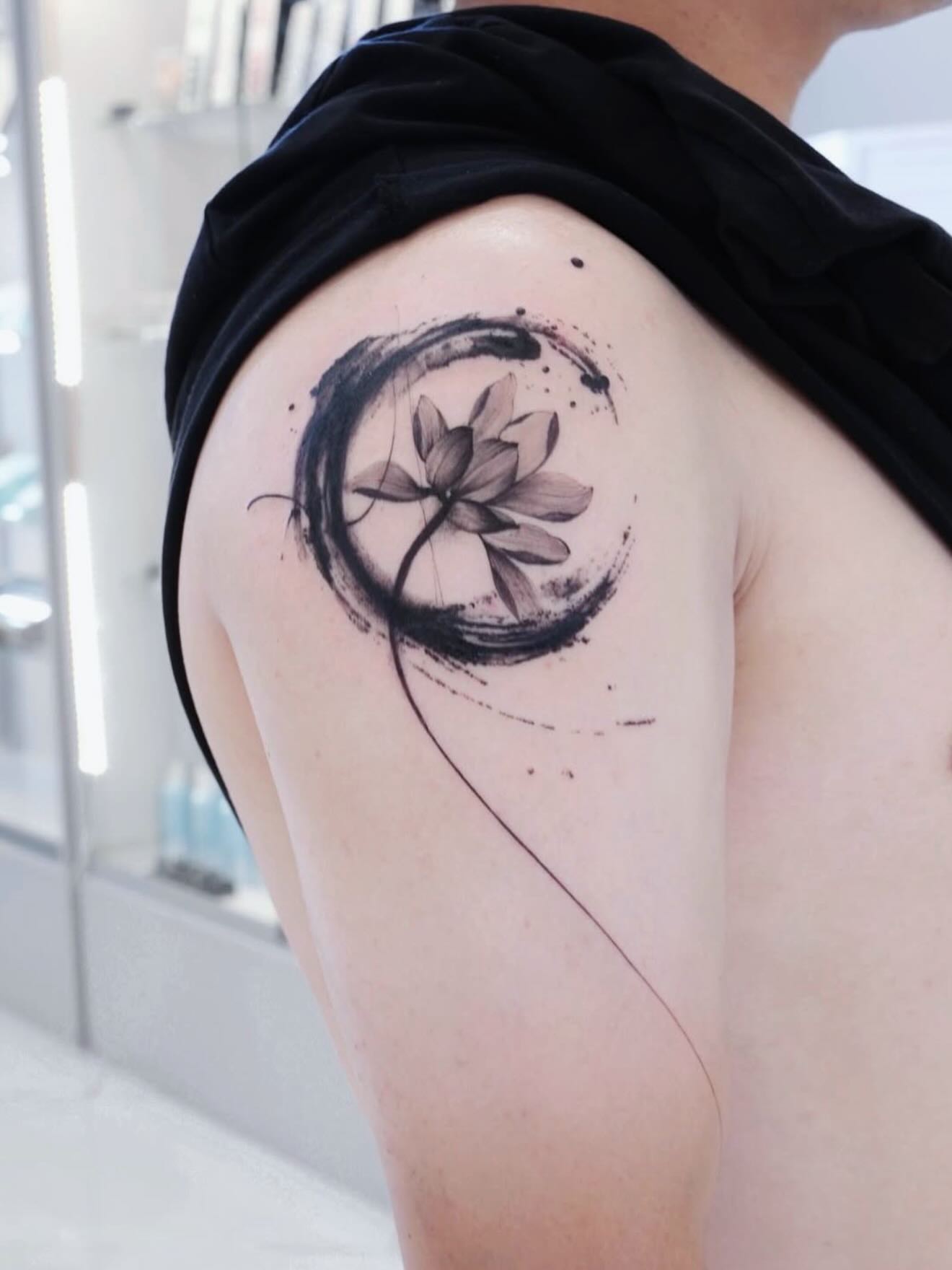 Lotus flower black and grey tattoo on the shoulder by MJ tattooist