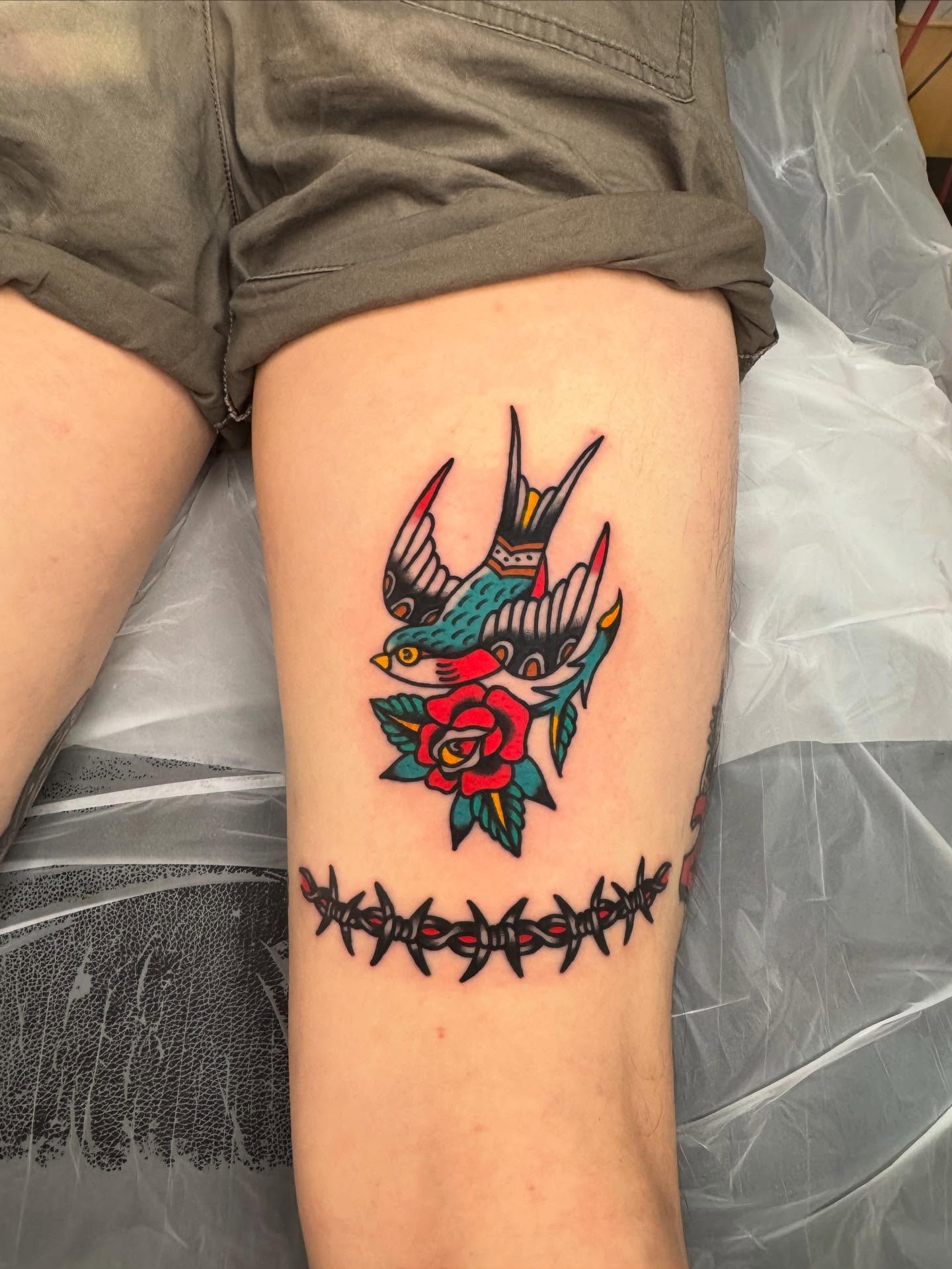 Swallows and rose American traditional tattoo on the thigh by Oldschool Tattooer