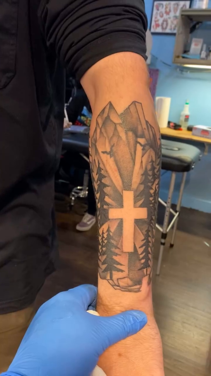 Cross with mountains and trees fine line tattoo on the forearm by jim collins, Dayton, Ohio