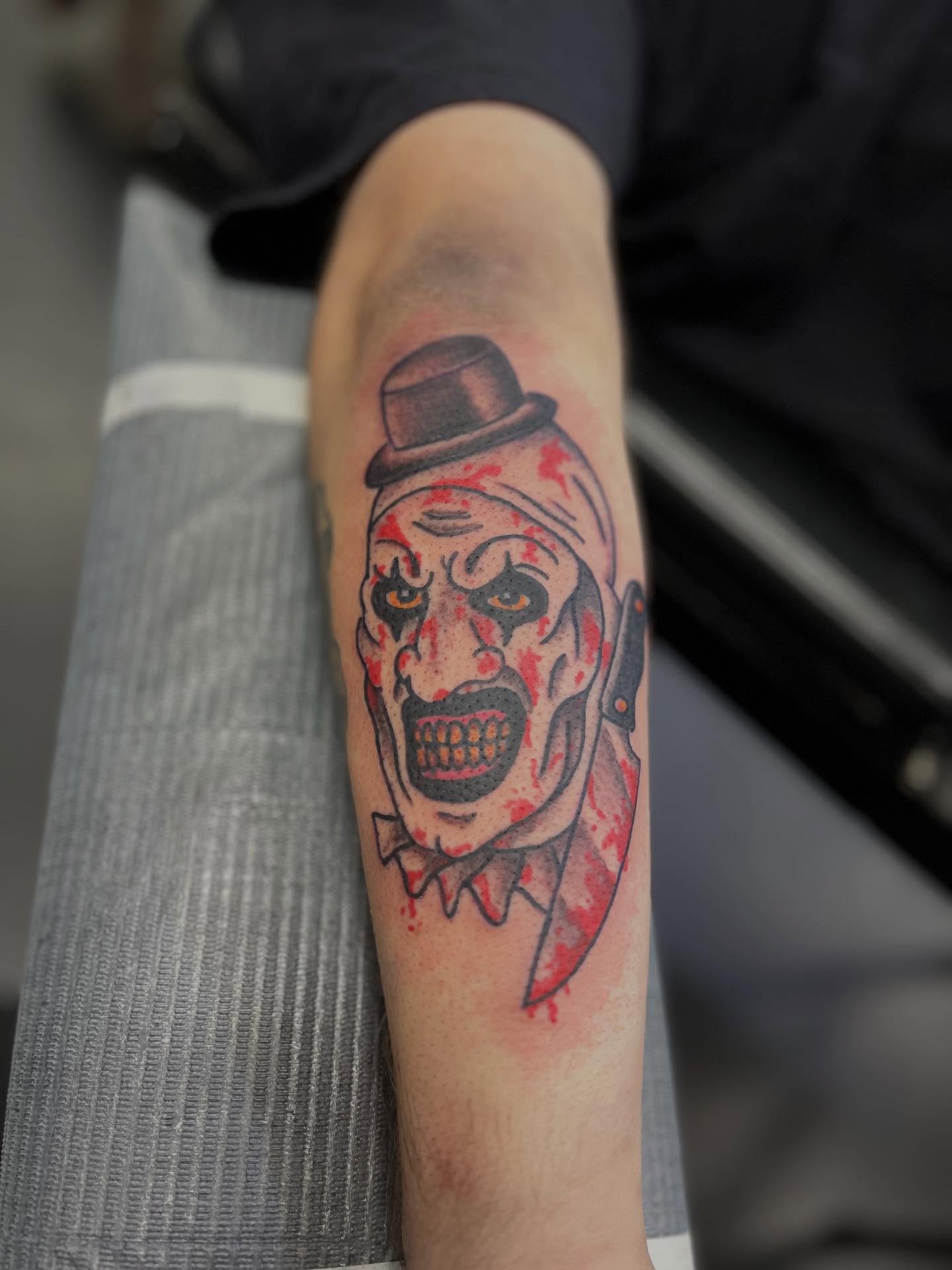 Clown with knife dark realism tattoo on the forearm by CRAIG B⛓️ Cincinnati Tattoo Artist