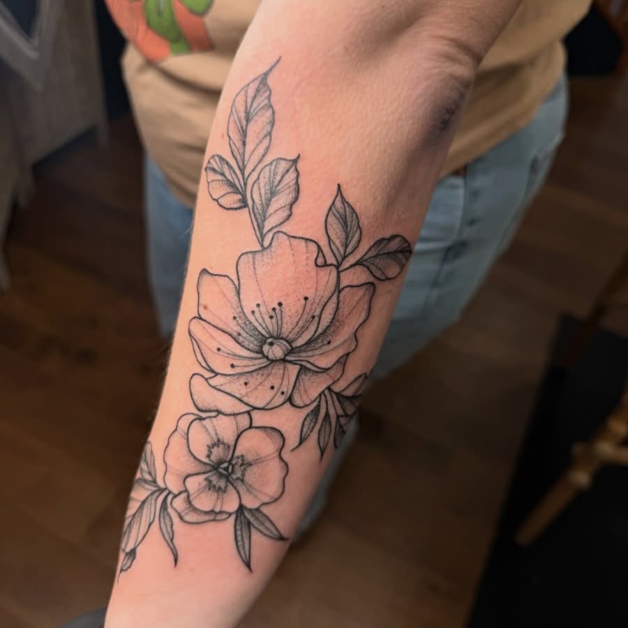 Flowers black and grey tattoo on the forearm by Erica Rose π€