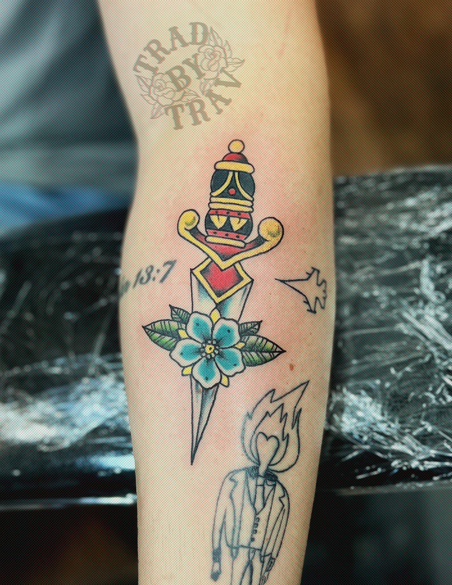 Sword and flower American traditional tattoo on the forearm by Travis B