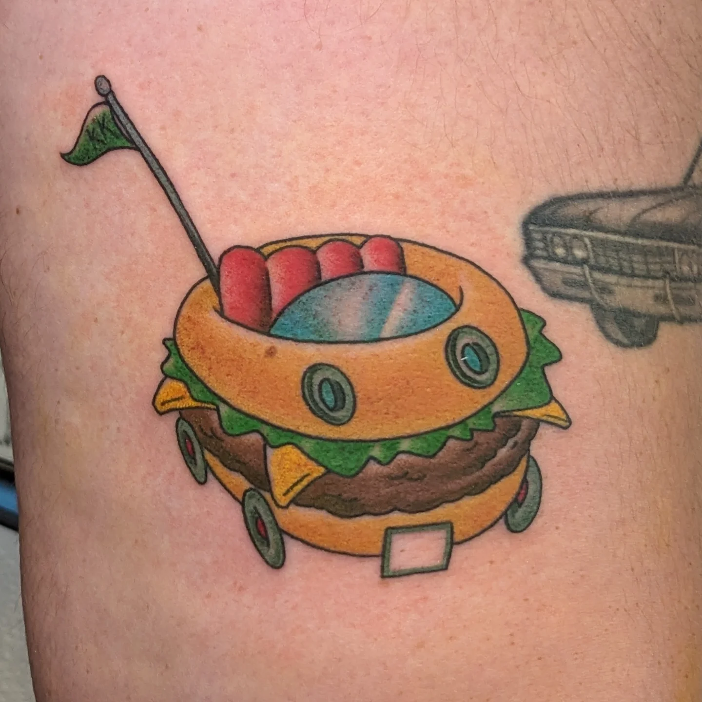 Hamburger new school tattoo on the thigh by Matt Simmonds