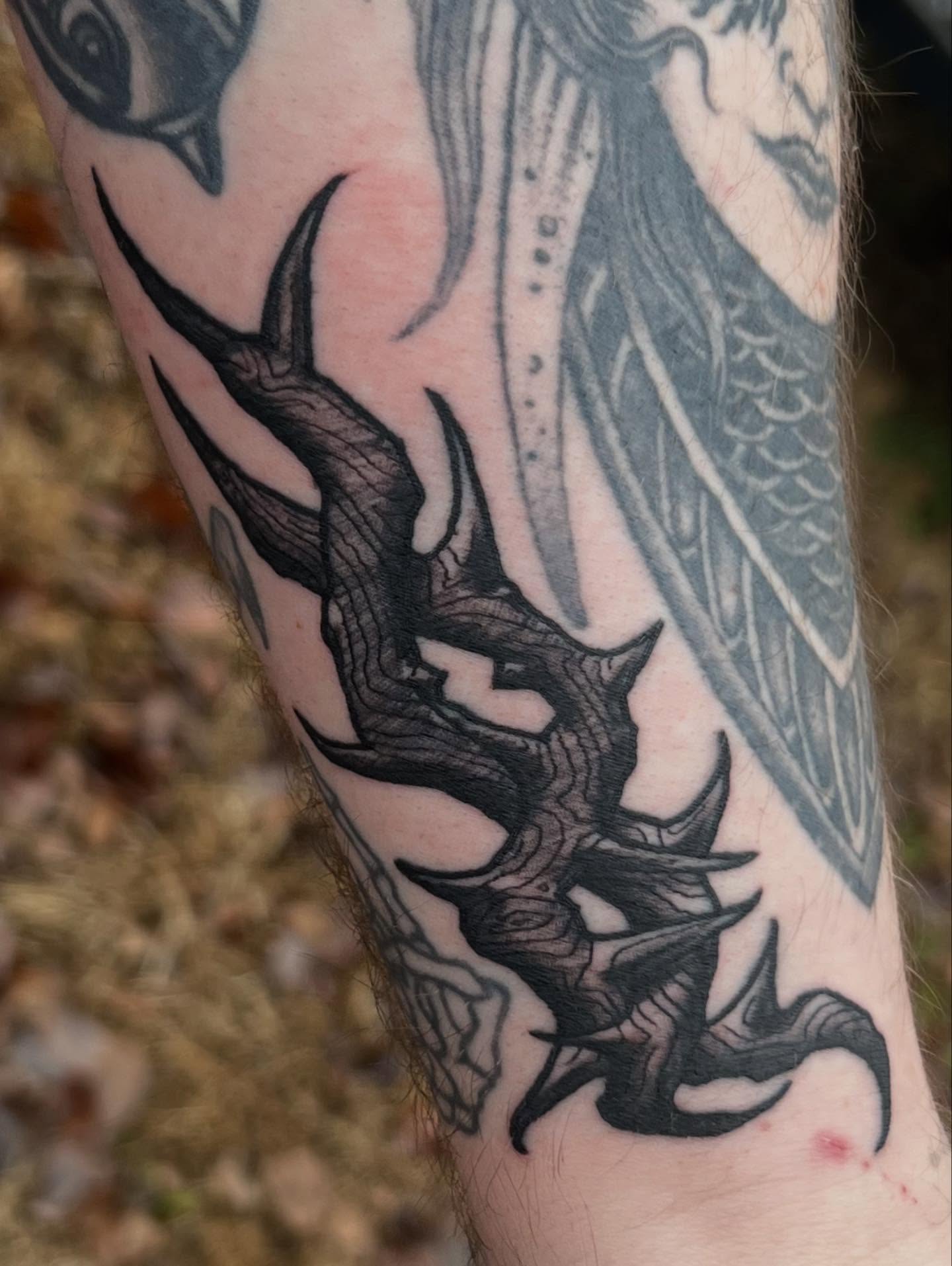 Dragon black and grey tattoo on the forearm by Lord Daniel Serna