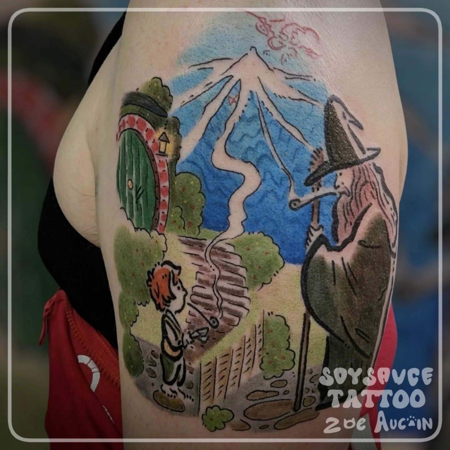 The hobbit and wizard illustrative tattoo on the forearm by Zoe Aucoin