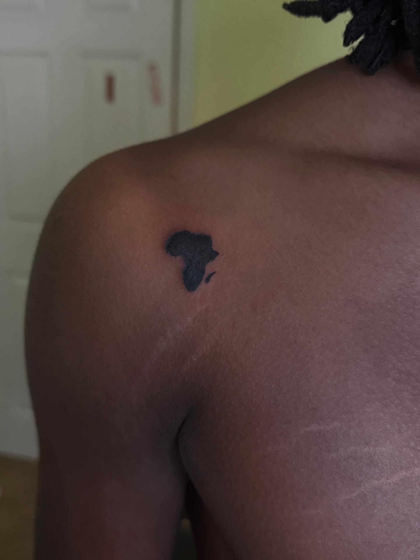 Map of Africa black and grey tattoo on the shoulder by Destini