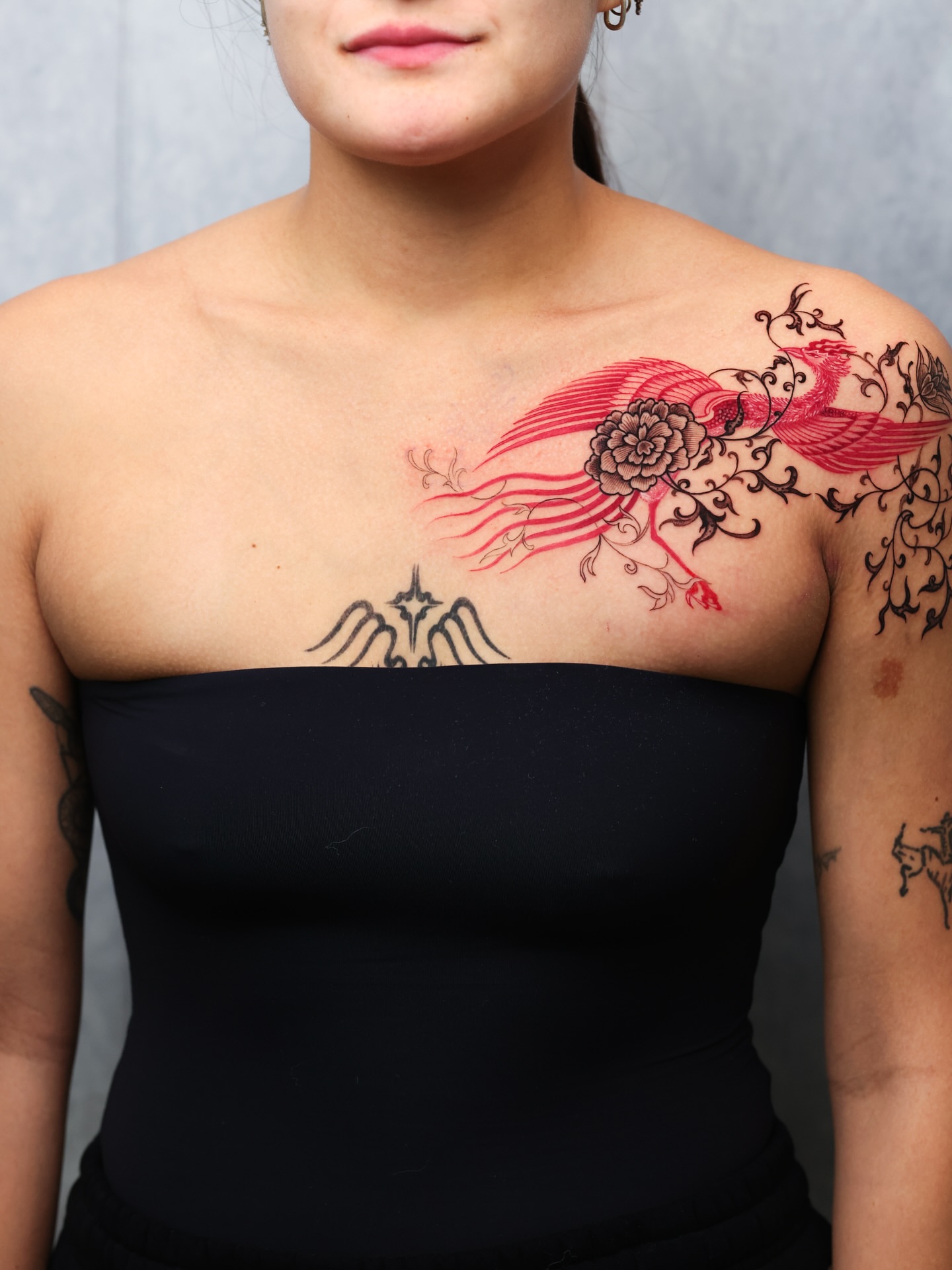 Phoenix and flower neo-traditional tattoo on the chest by Swani
