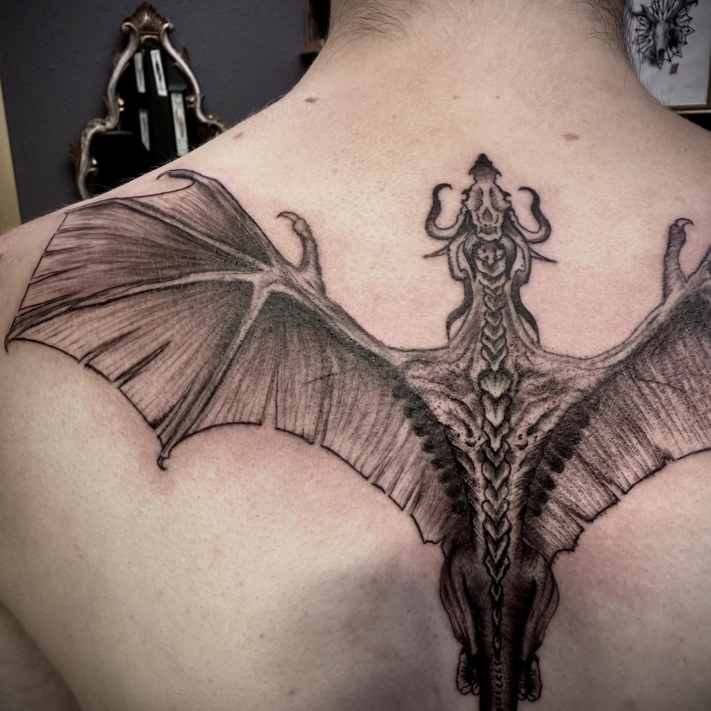 Dragon black and grey tattoo on the back by C. Compa