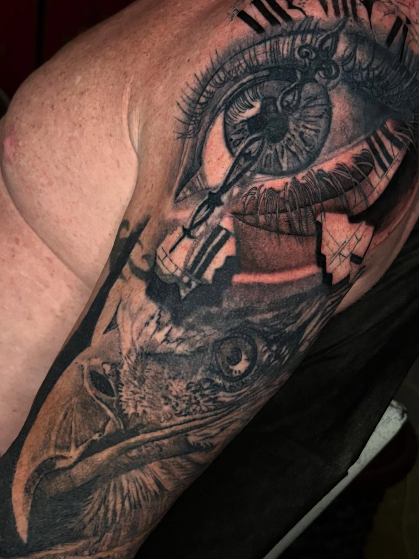Eye and crow realism tattoo on the upper arm by Misty Locket Realism Tattoo Artist Cover-up