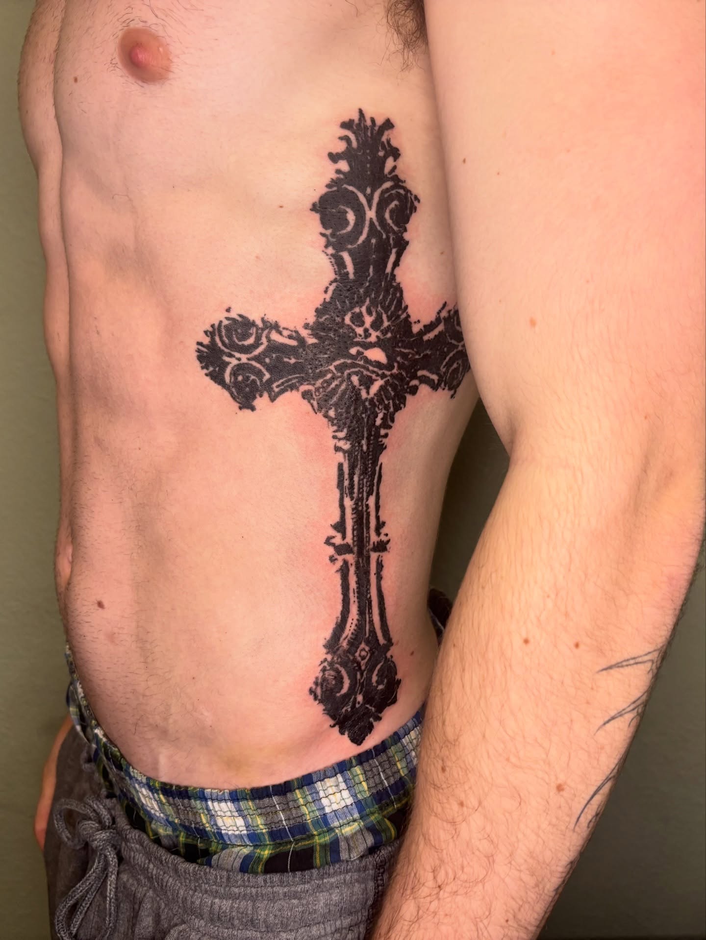 Cross black and grey tattoo on the torso by @miffythereaper