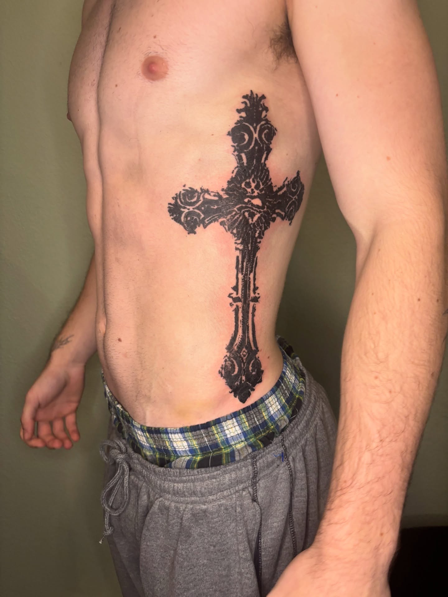 Cross black and grey tattoo on the torso by @miffythereaper