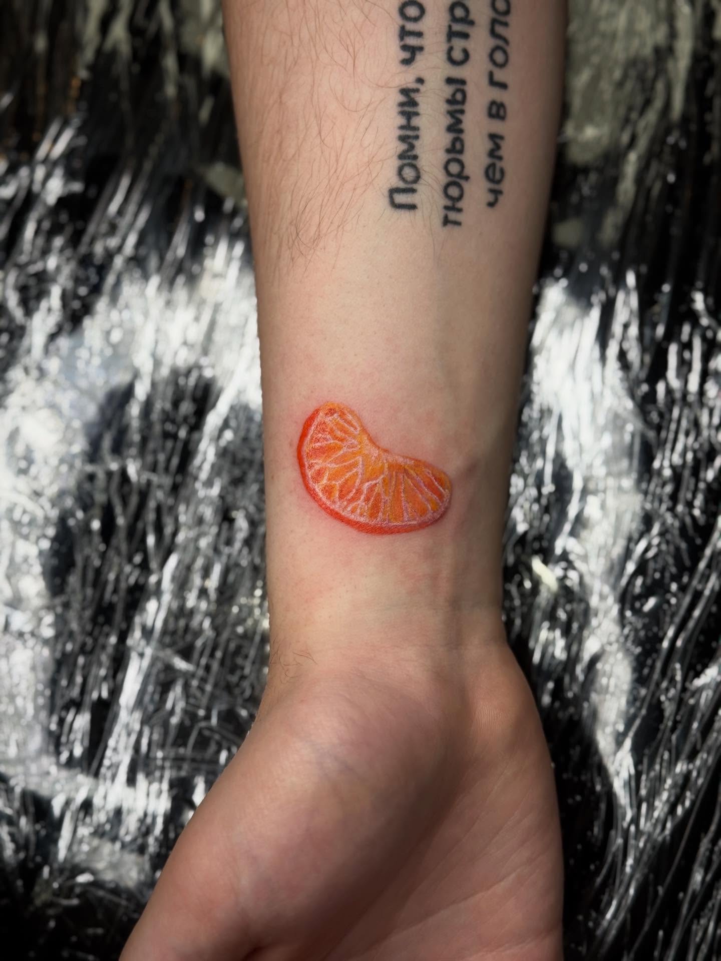 Orange slice realism tattoo on the forearm by Ashley Hsiung *Panda*