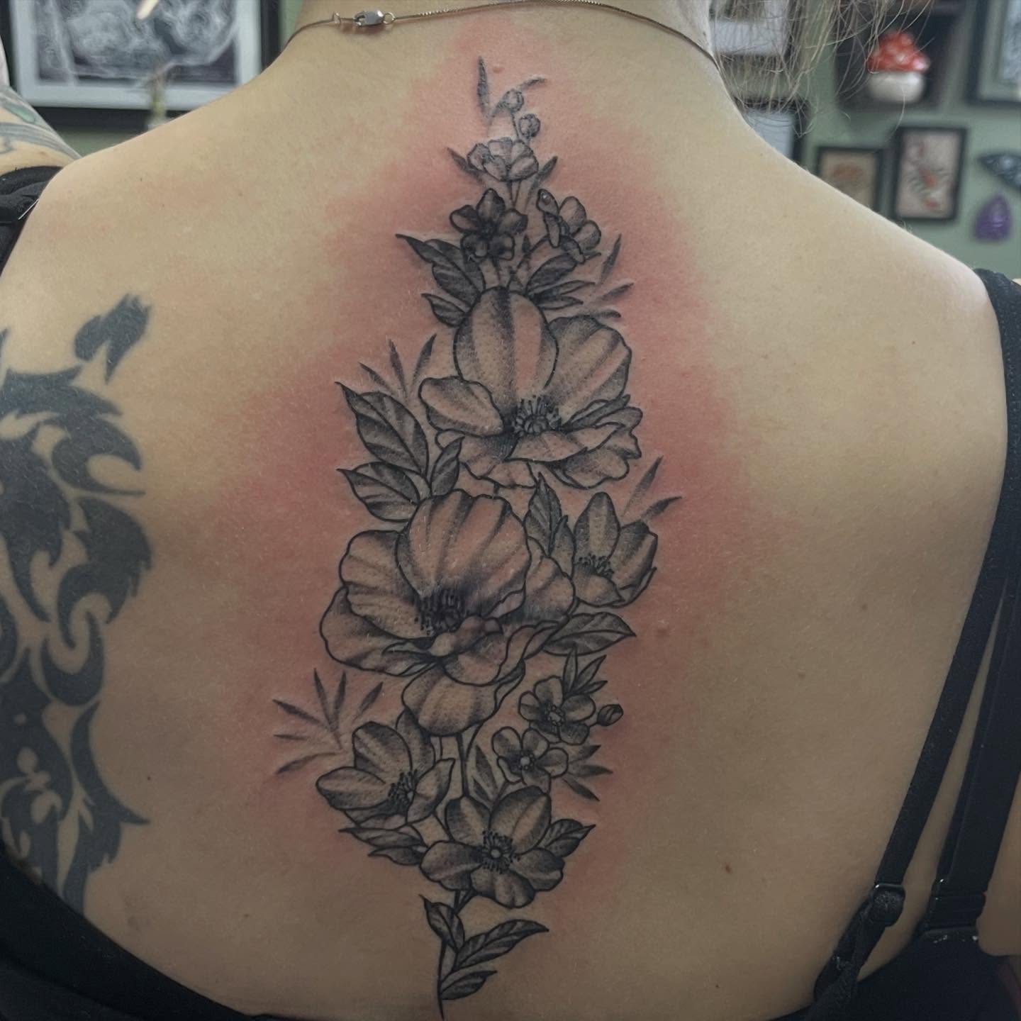 Floral arrangement black and grey tattoo on the back by Tina Gregg, North Ridgeville, Ohio