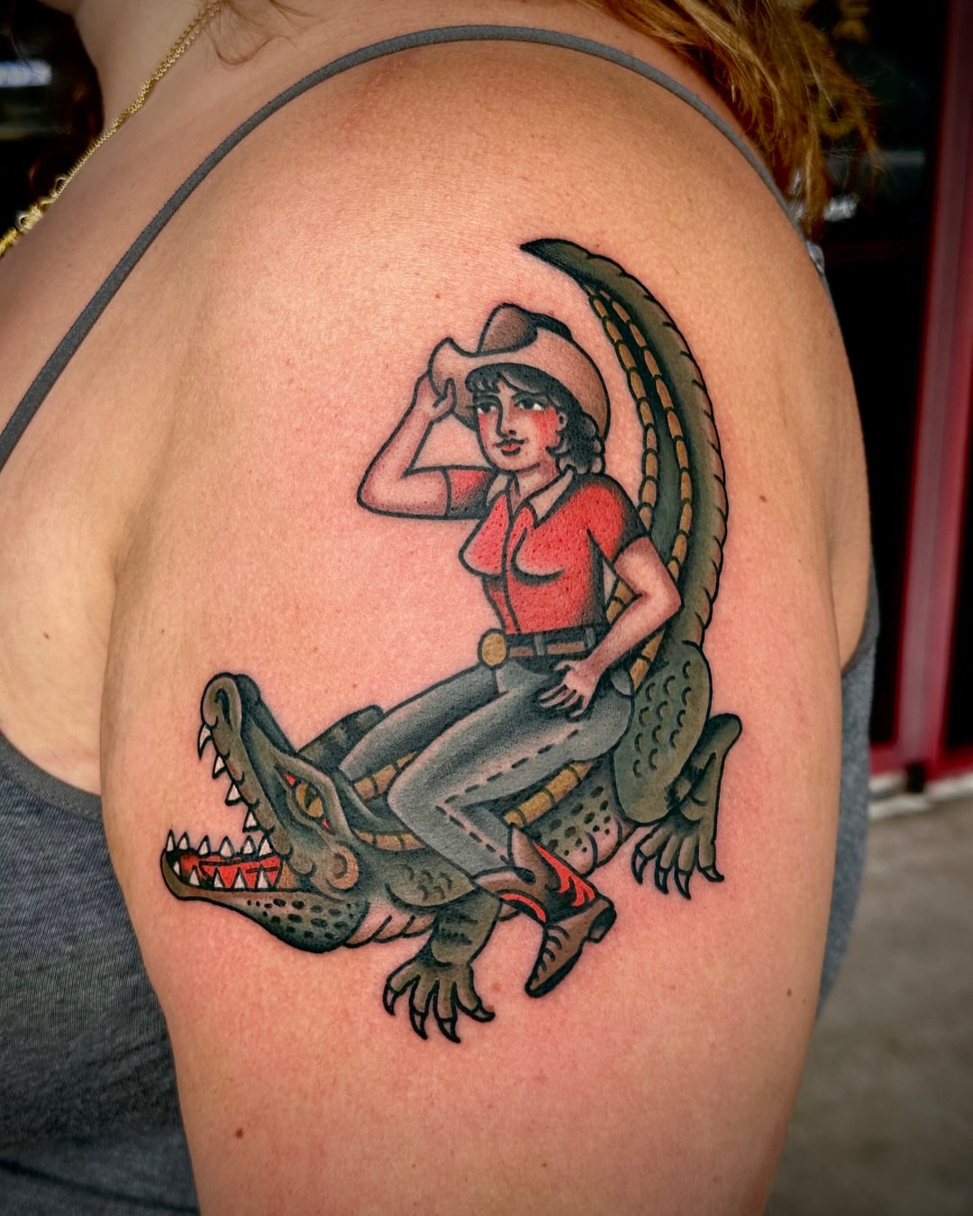 Cowgirl riding crocodile American traditional tattoo on the shoulder by Tony Perez- Austin Texas Tattooer