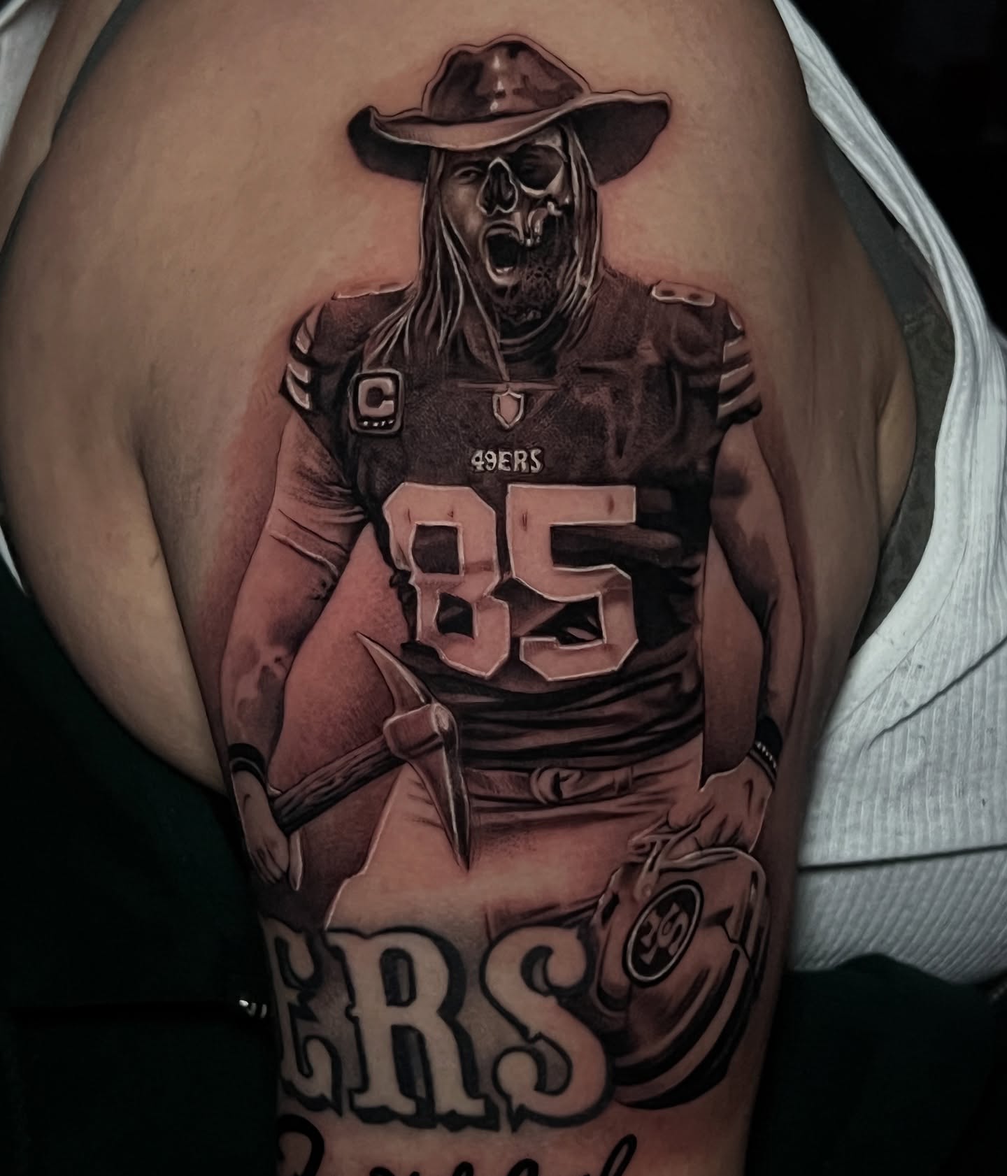 49ers player with cowboy hat realism tattoo on the upper arm by Flames, Cerritos, California