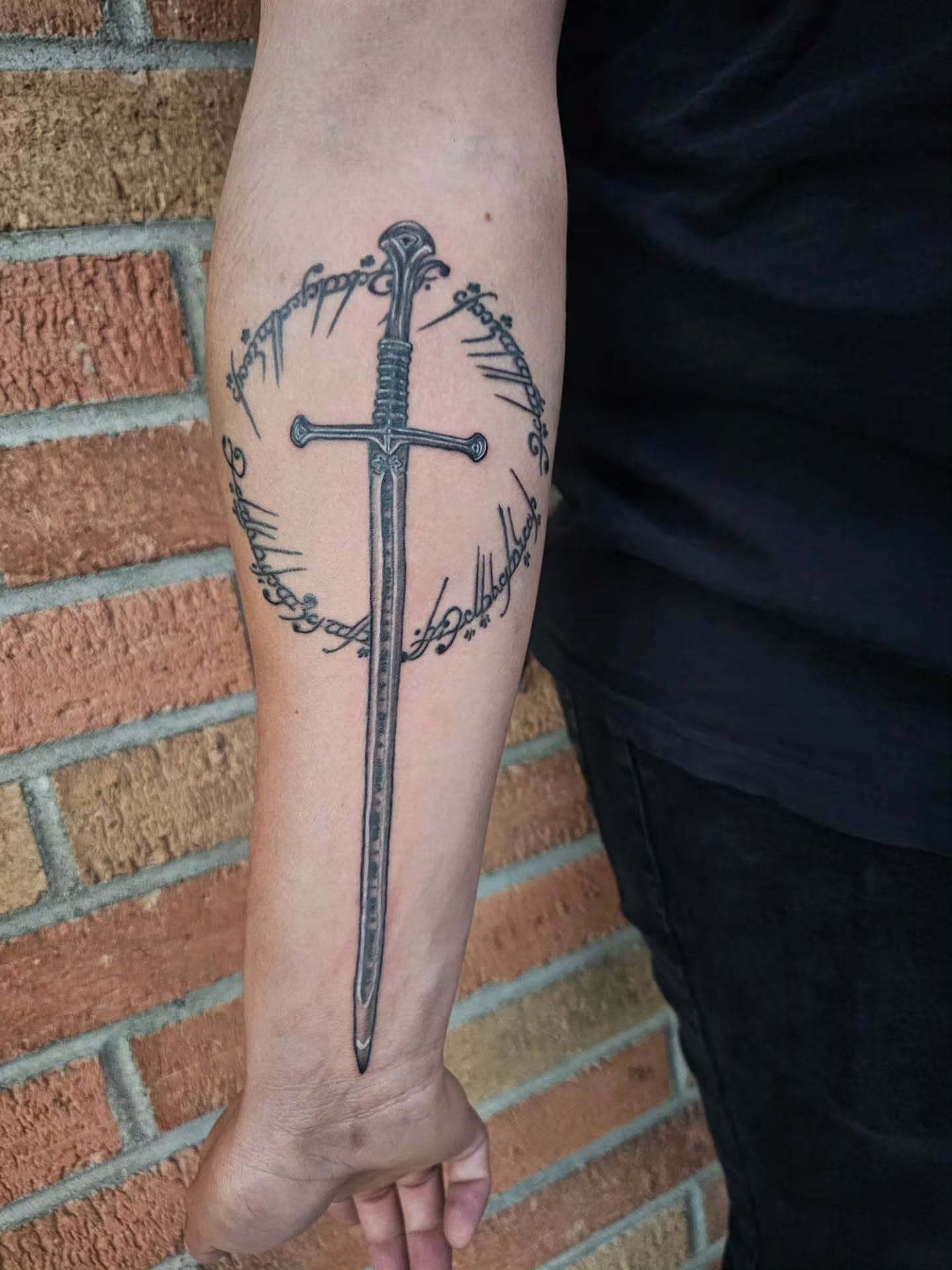 Sword black and grey tattoo on the forearm by J. Arturo Laparra