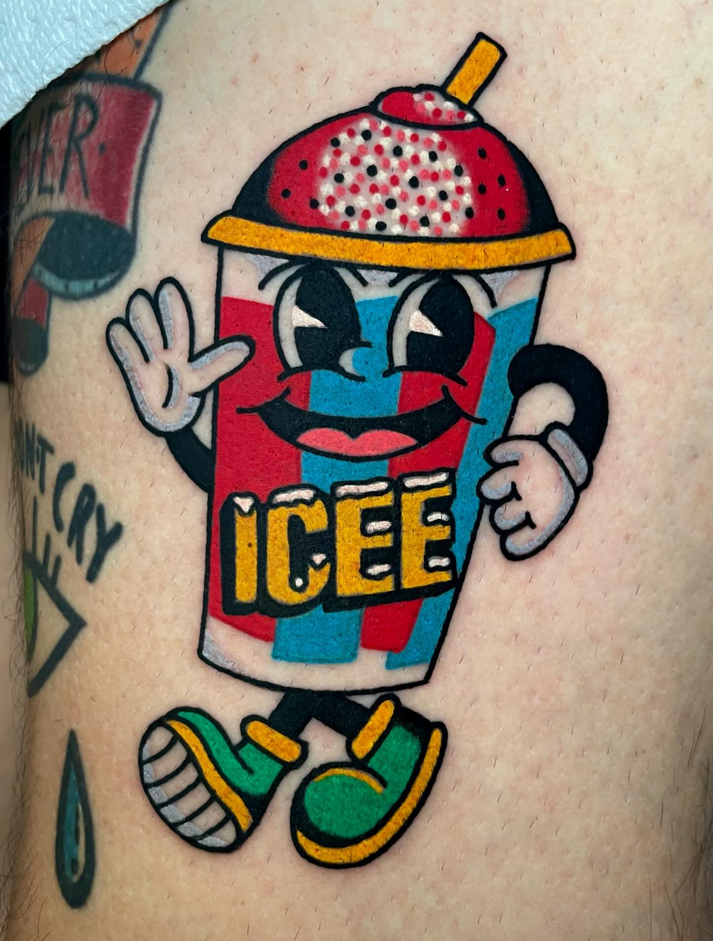 Icee character American traditional tattoo on the thigh by Ryan McDonald
