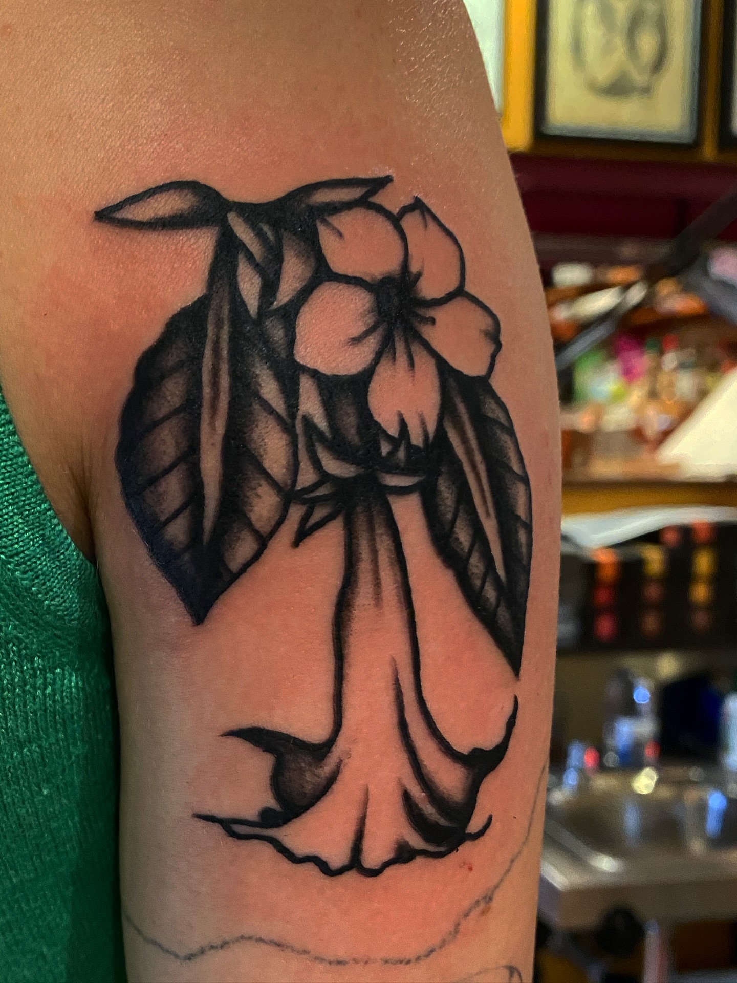 Flower with wings black and grey tattoo on the forearm by Joey Delarosa, San Francisco, California