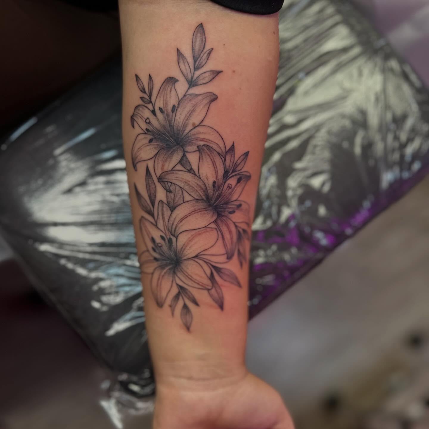 Lilies black and grey tattoo on the forearm by Vegas Tattoo Mommy ๐๐, Las Vegas, Nevada
