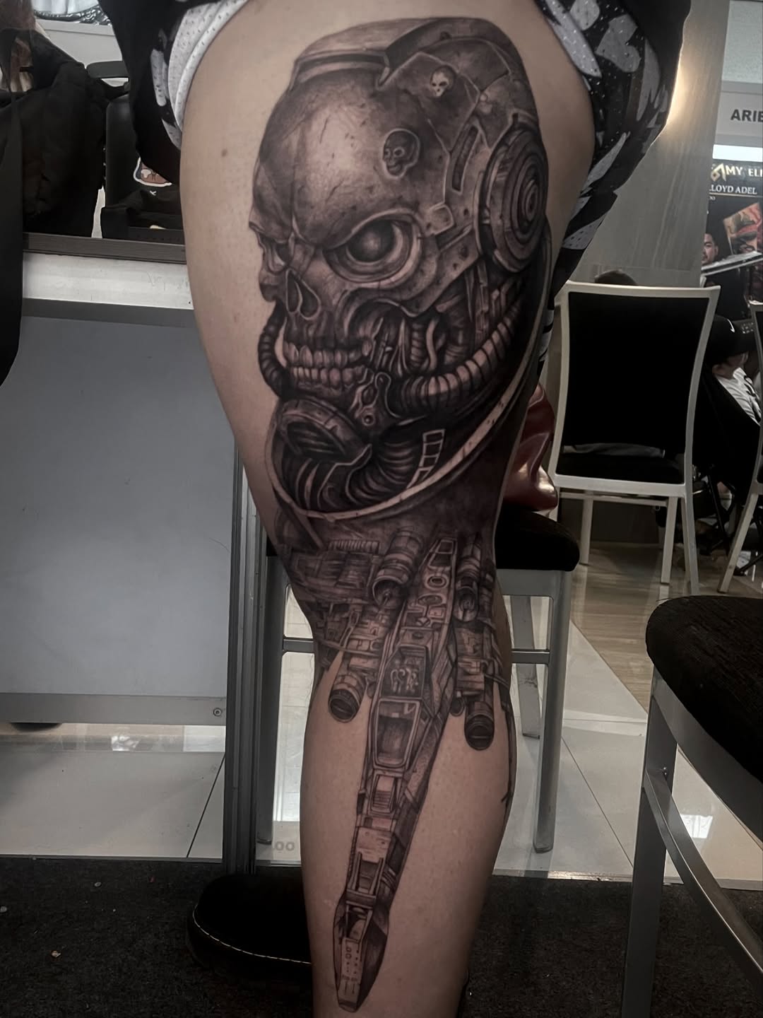 Biomechanical skull and spaceship realism tattoo on the thigh by Arhem Quiambao