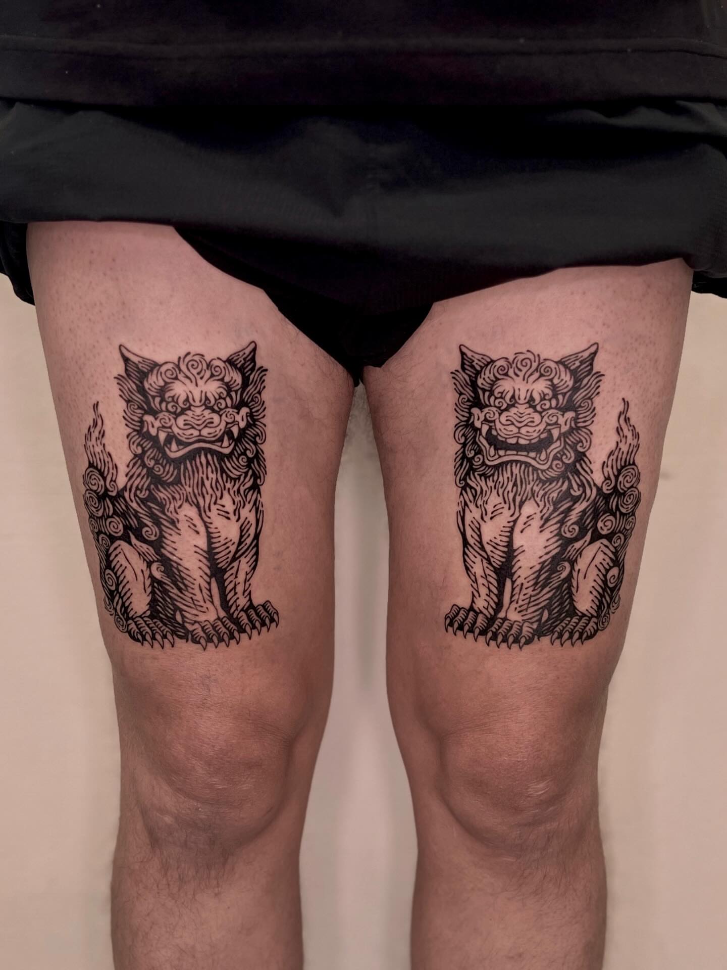 Lion statues black and grey tattoo on the thigh by Wonny