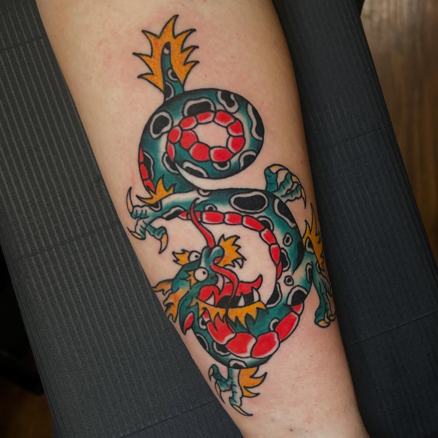 Serpent and ball American traditional tattoo on the thigh by 𝕸𝖞𝖆