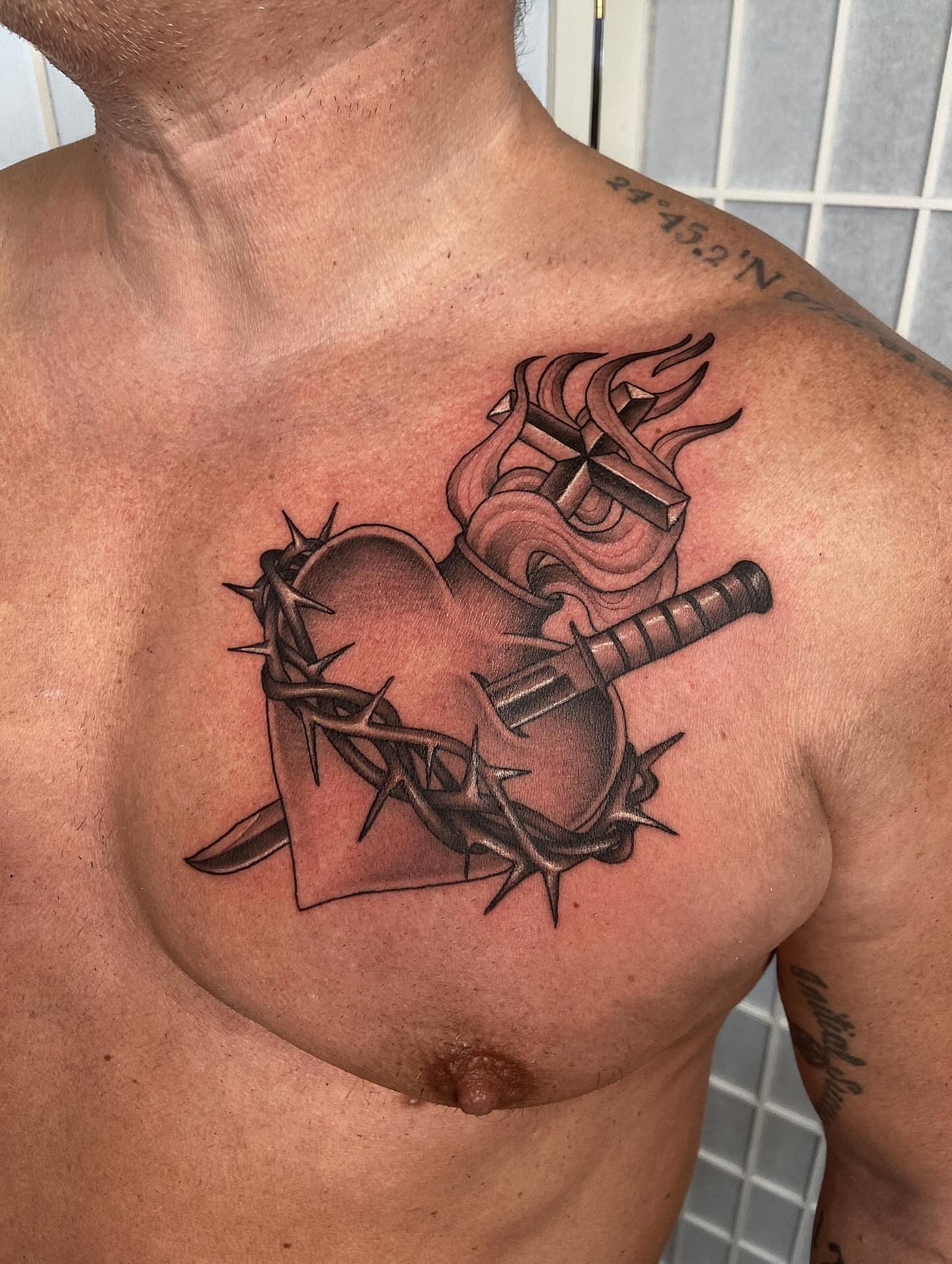 Heart and crown of thorns black and grey tattoo on the chest by Tattoos by Dale Hupke, Lebanon, Ohio