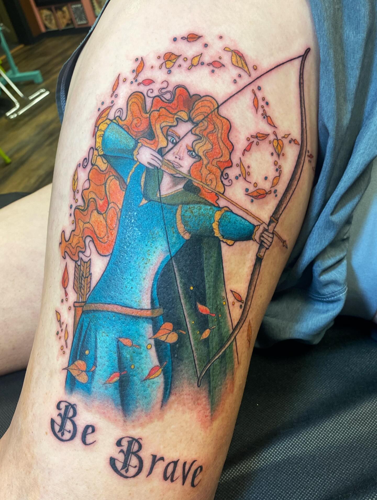 Merida illustrative tattoo on the thigh by Casey Dohner