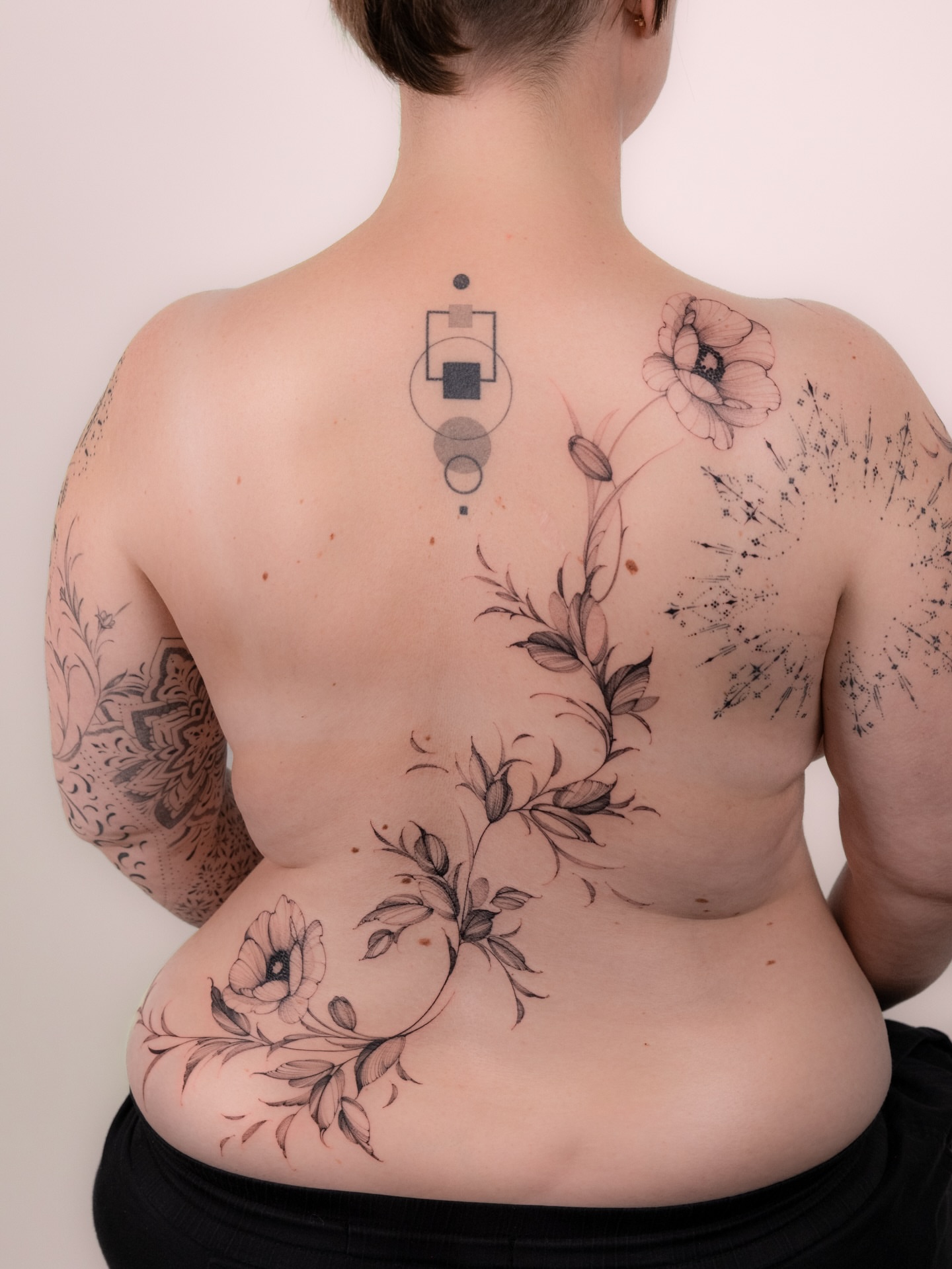 Floral arrangement geometric tattoo on the back by i flower you
