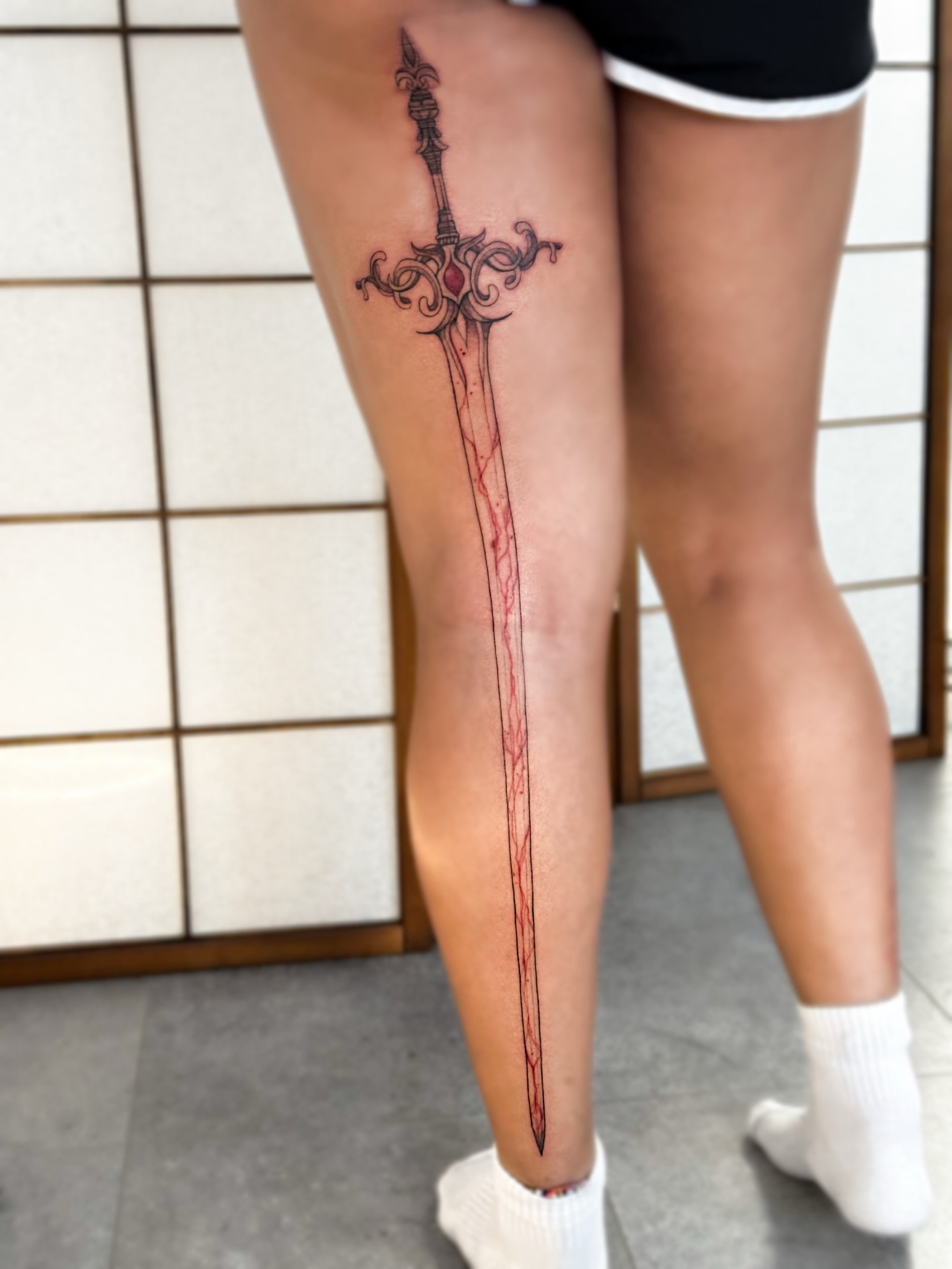 Sword ornamental tattoo on the thigh by Mila, Riga, Latvia