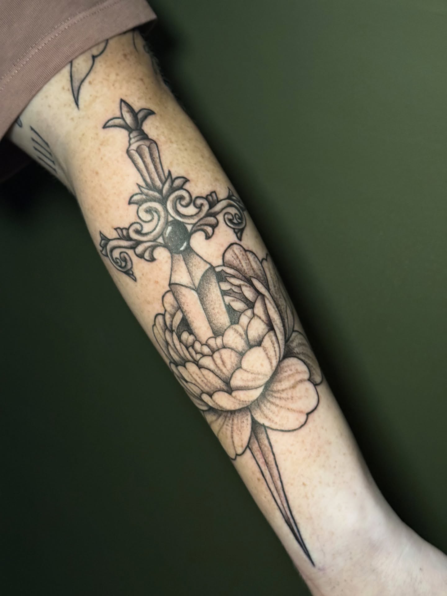 Cross and flower ornamental tattoo on the forearm by Whimsical illustrative