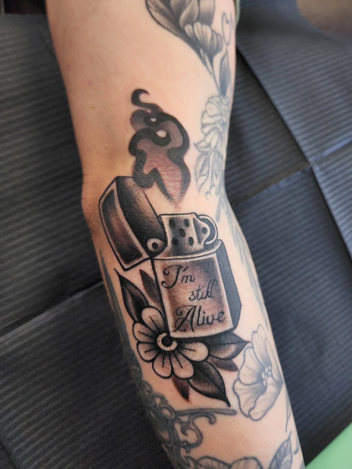 Lighter with text American traditional tattoo on the forearm by Shawna Goettsche