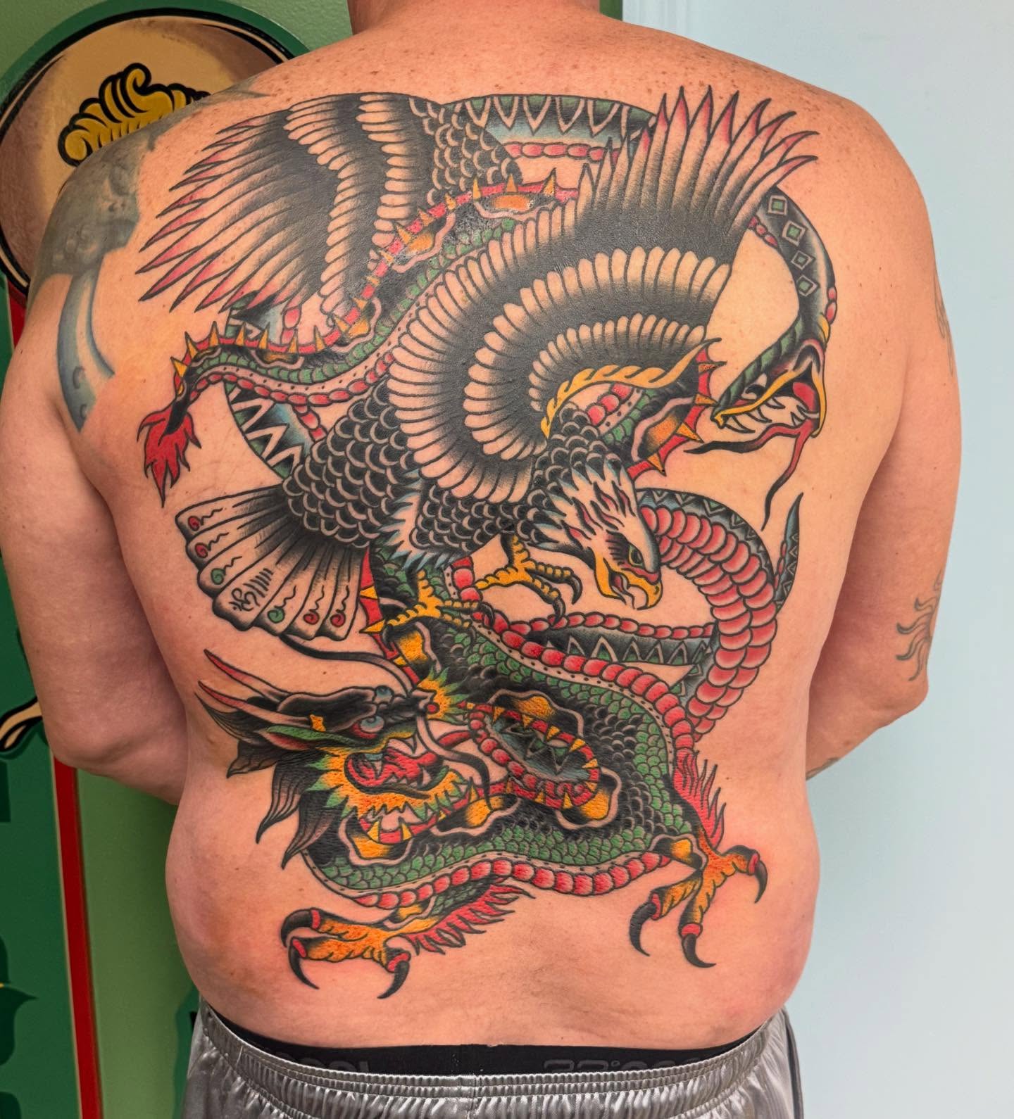Dragon American traditional tattoo on the back by Jesse Coldiron