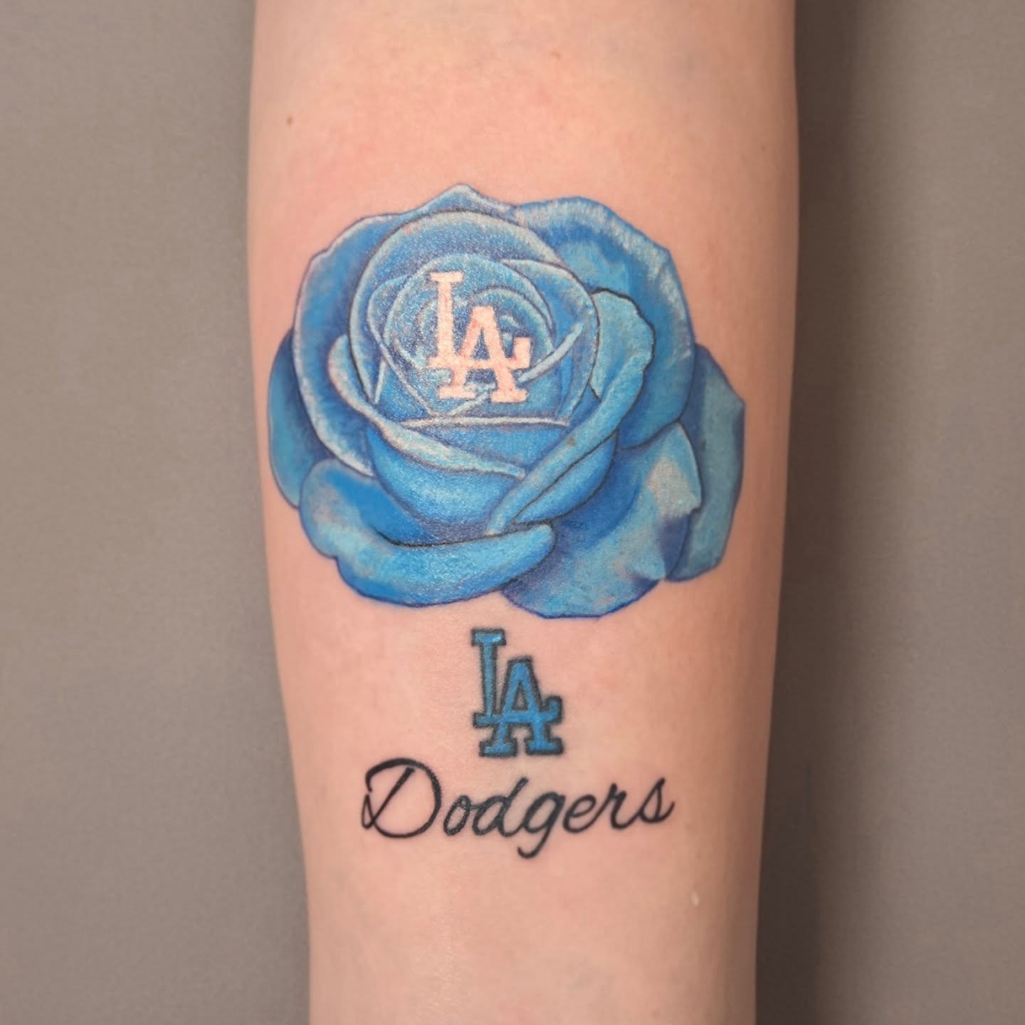 Blue rose with LA Dodgers logo realism tattoo on the forearm by Jose G. Rubio Tattoo Artist πΊπ²ππ¨π¦