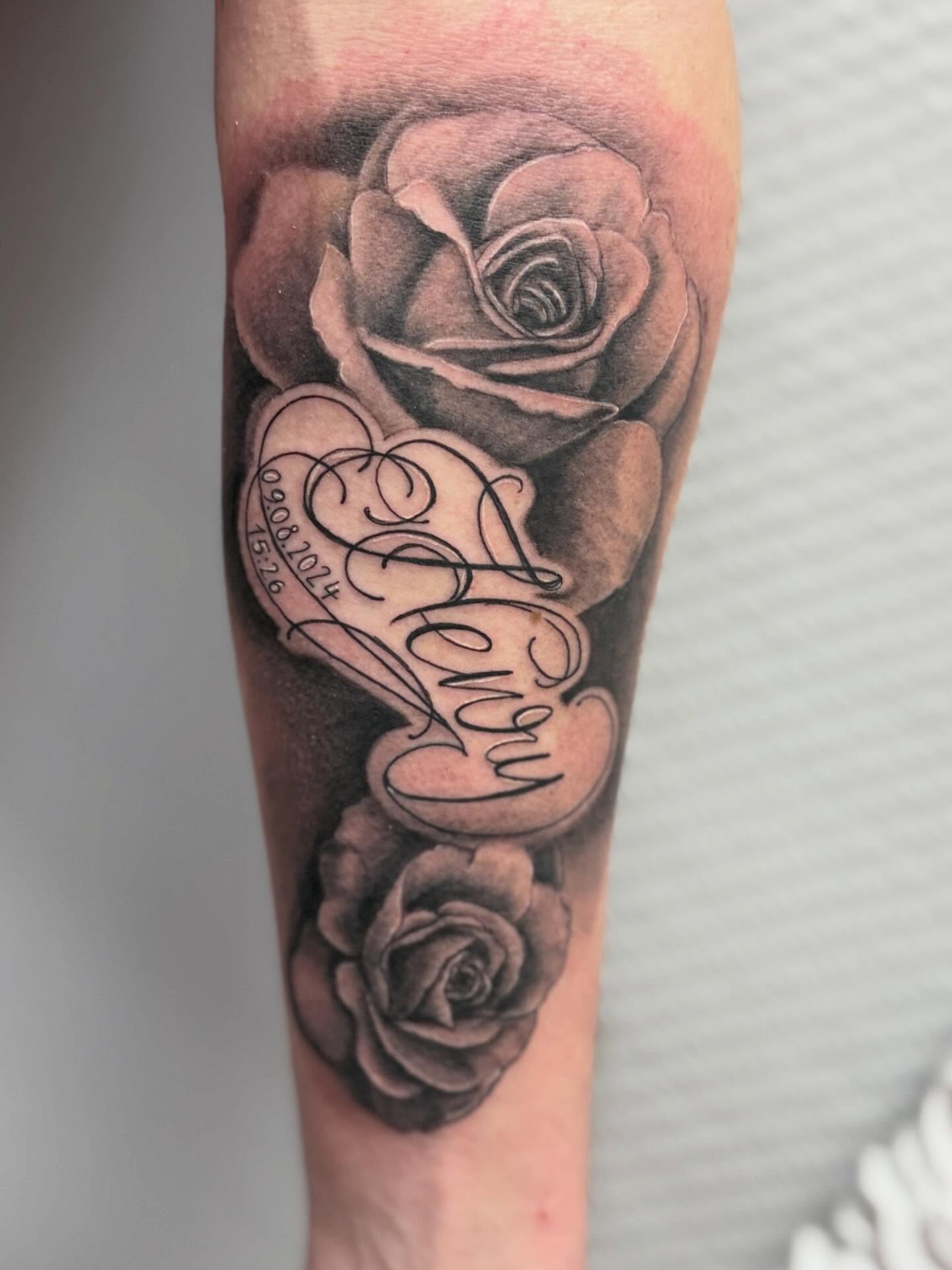 Roses and cursive realism tattoo on the forearm by Die Ivo, Bielefeld, Germany