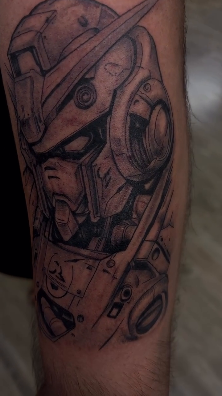 Gundam robot head realism tattoo by Ryan Walker