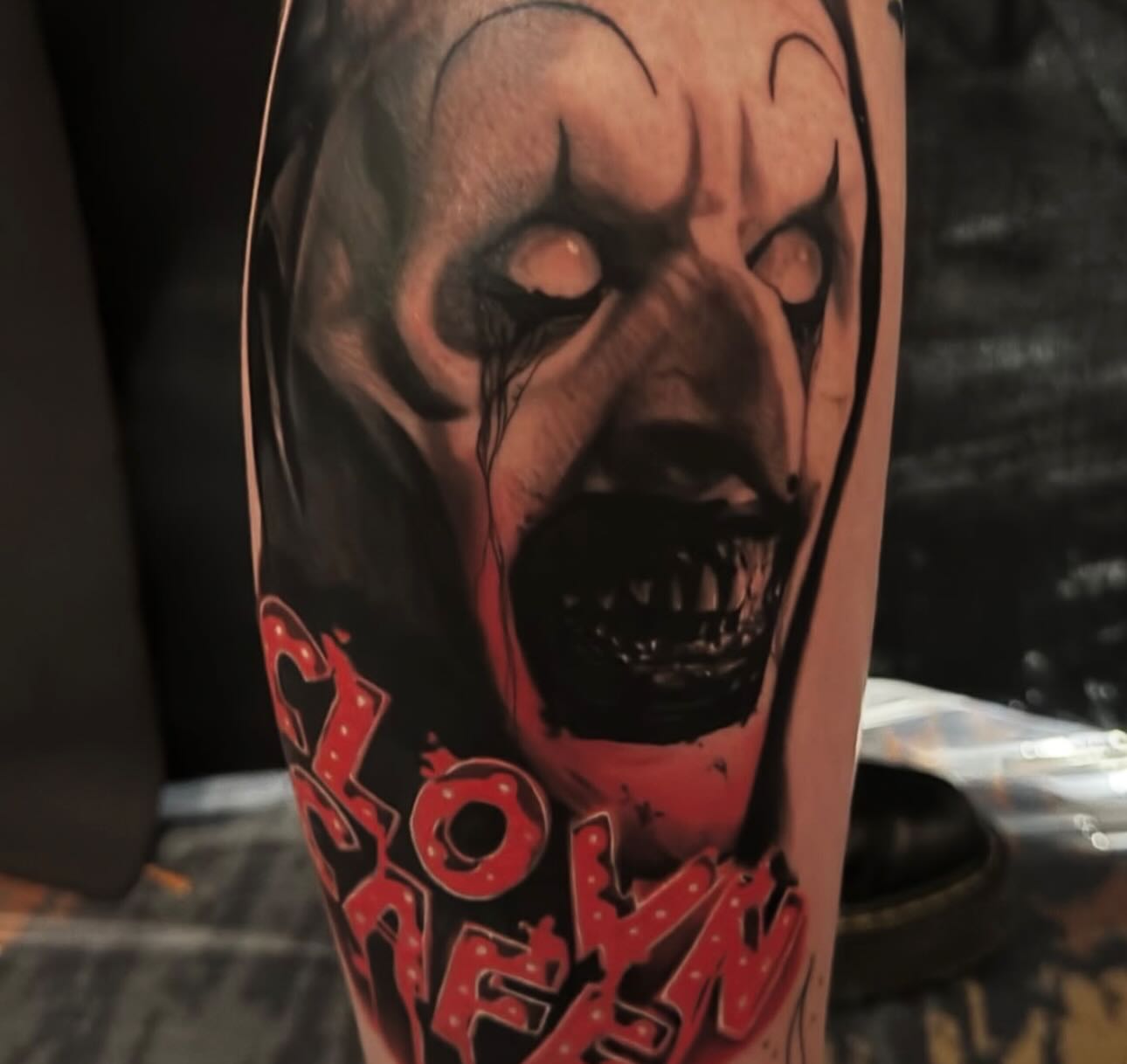 Clown face realism tattoo on the forearm by Sideshow Danny
